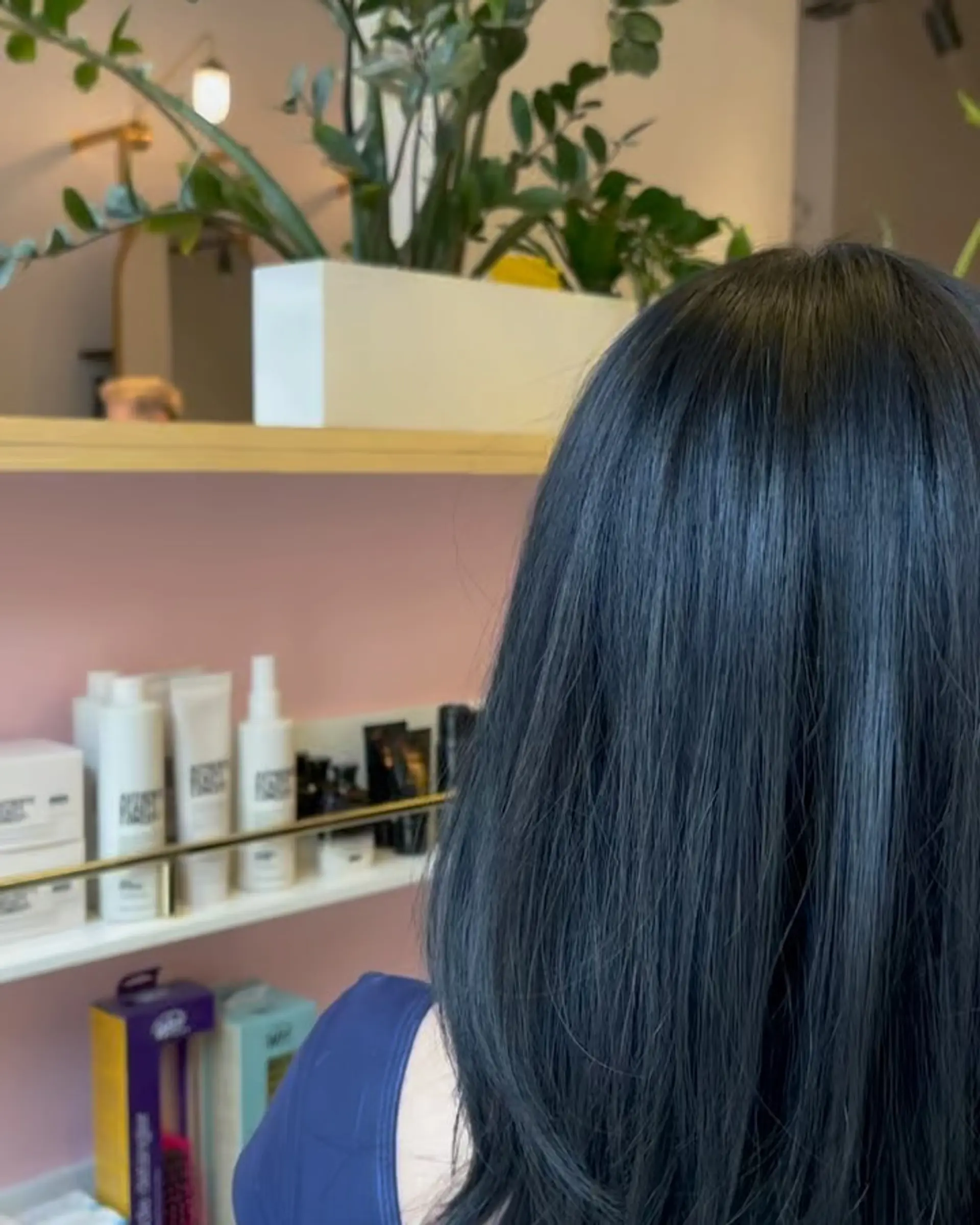 Medium-length straight dark hair styled with soft layers and a smooth, glossy finish. 1