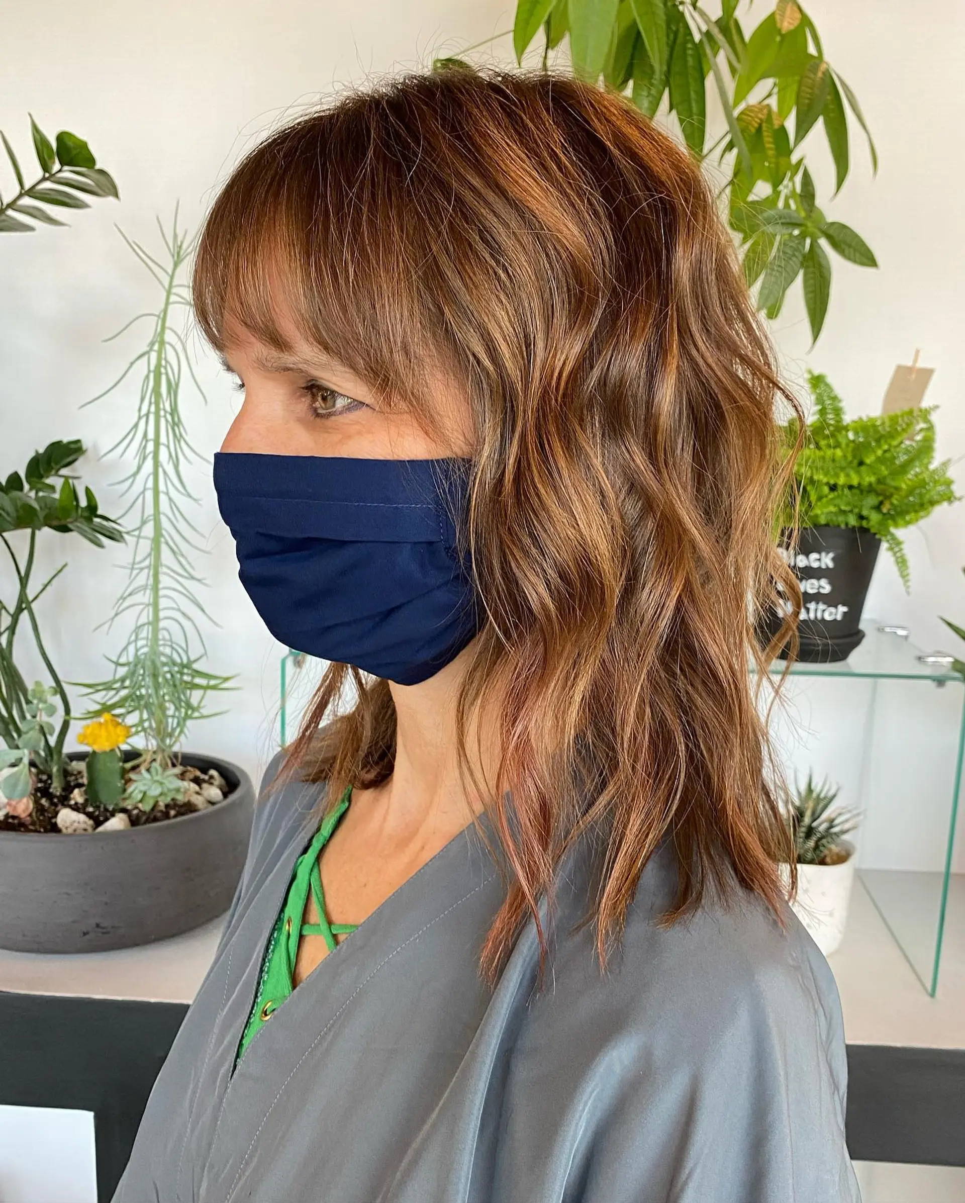 A medium-length textured shag with loose, lived-in waves, piecey layers, and a full eyebrow-skimming fringe. 1