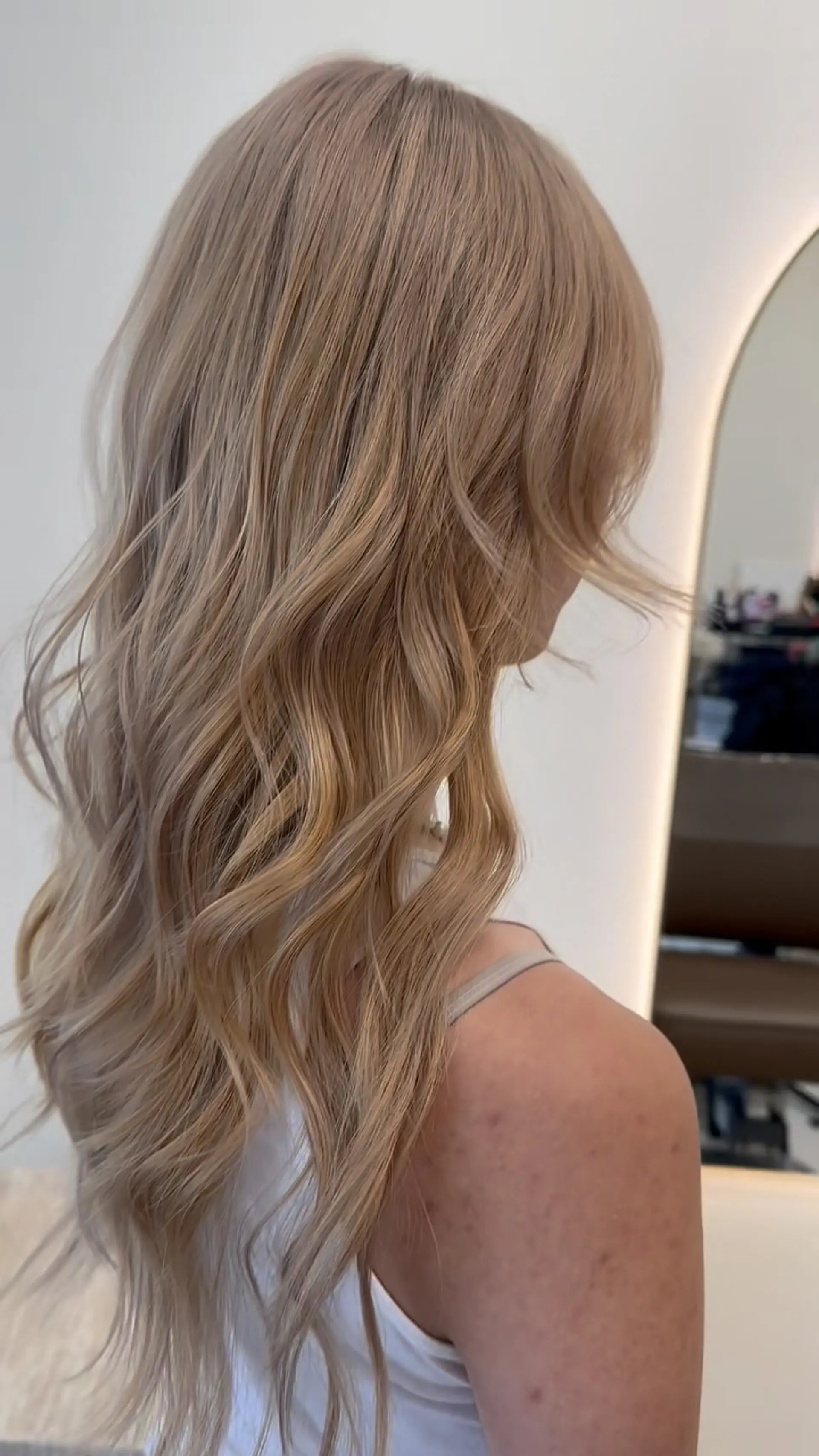 Long creamy champagne beige blonde hair styled with soft, effortless waves. 1