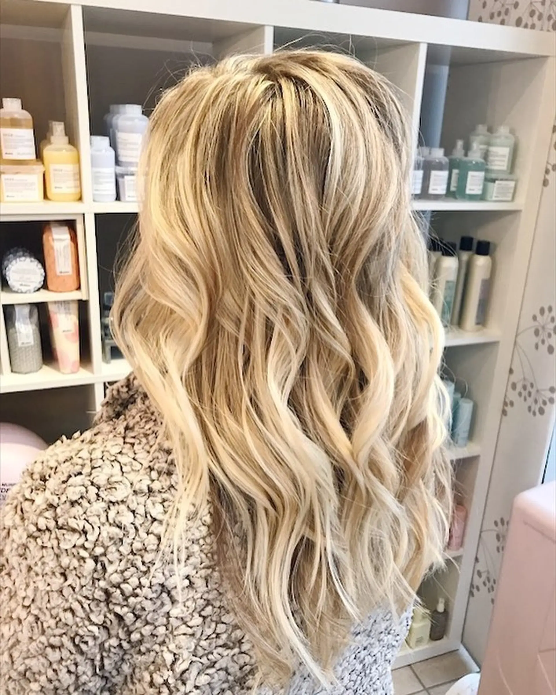 Long dimensional blonde hair styled into loose, effortless beach waves. 1