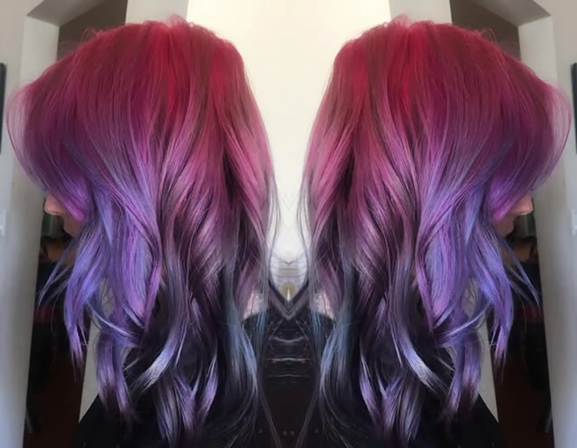 A vibrant ombre hairstyle with waves, transitioning from red to pink, purple, and black. 1