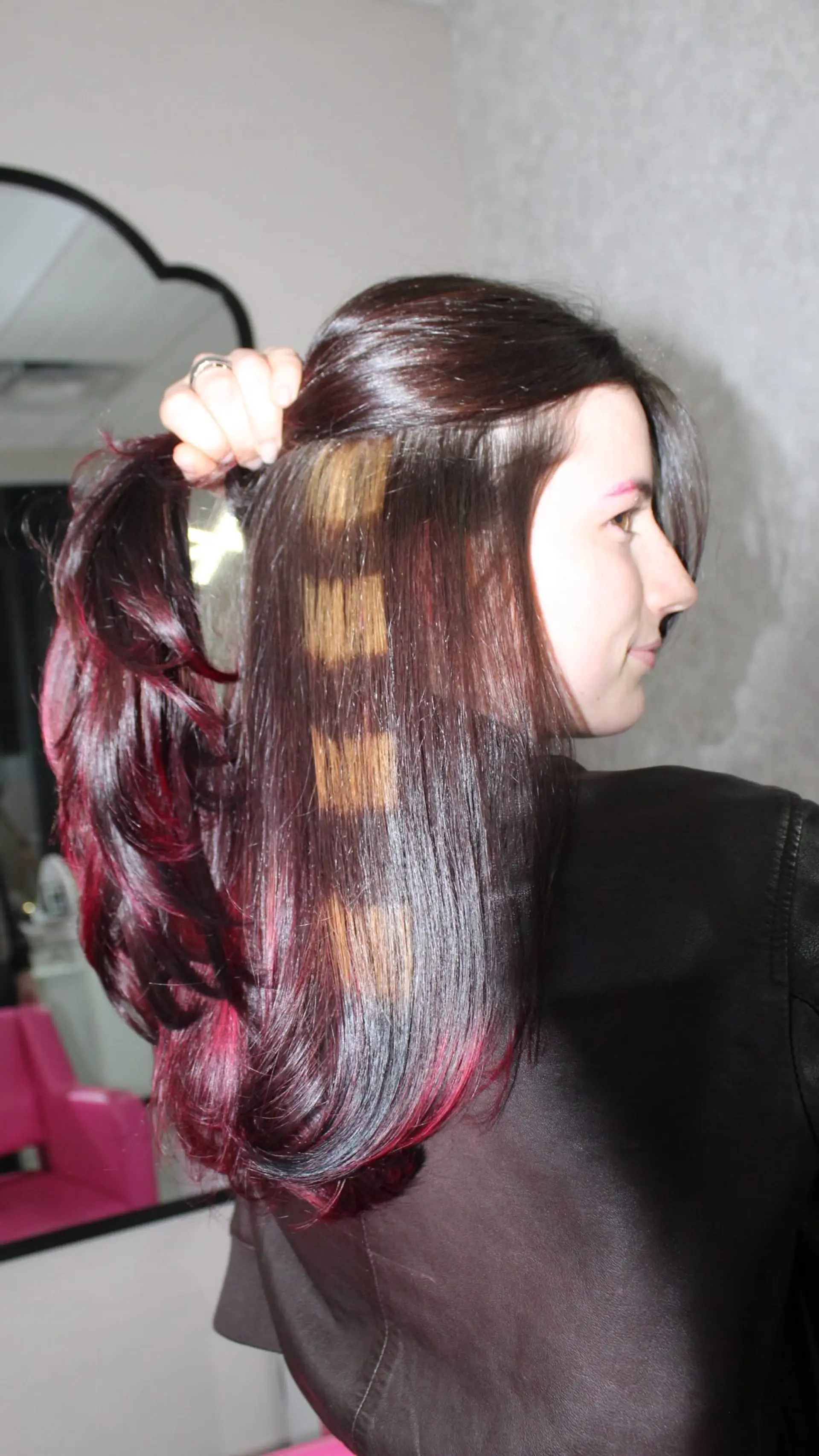 Medium-length dark hair styled with vibrant magenta underlights and distinct horizontal blonde raccoon tail stripes. 1