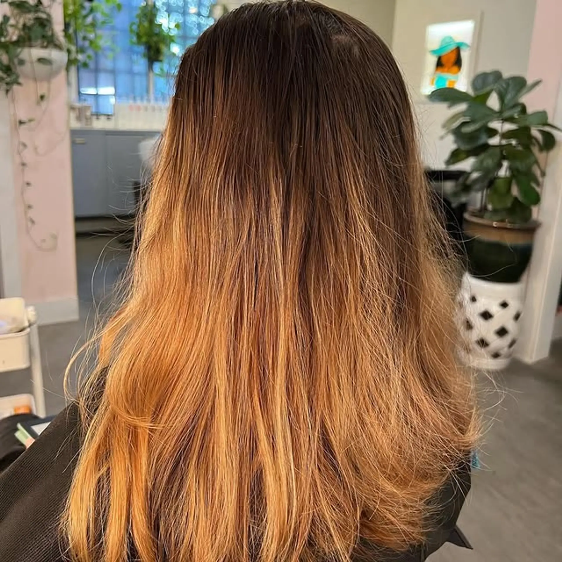 A long, wavy hairstyle with a bronzed ombre color effect. 1