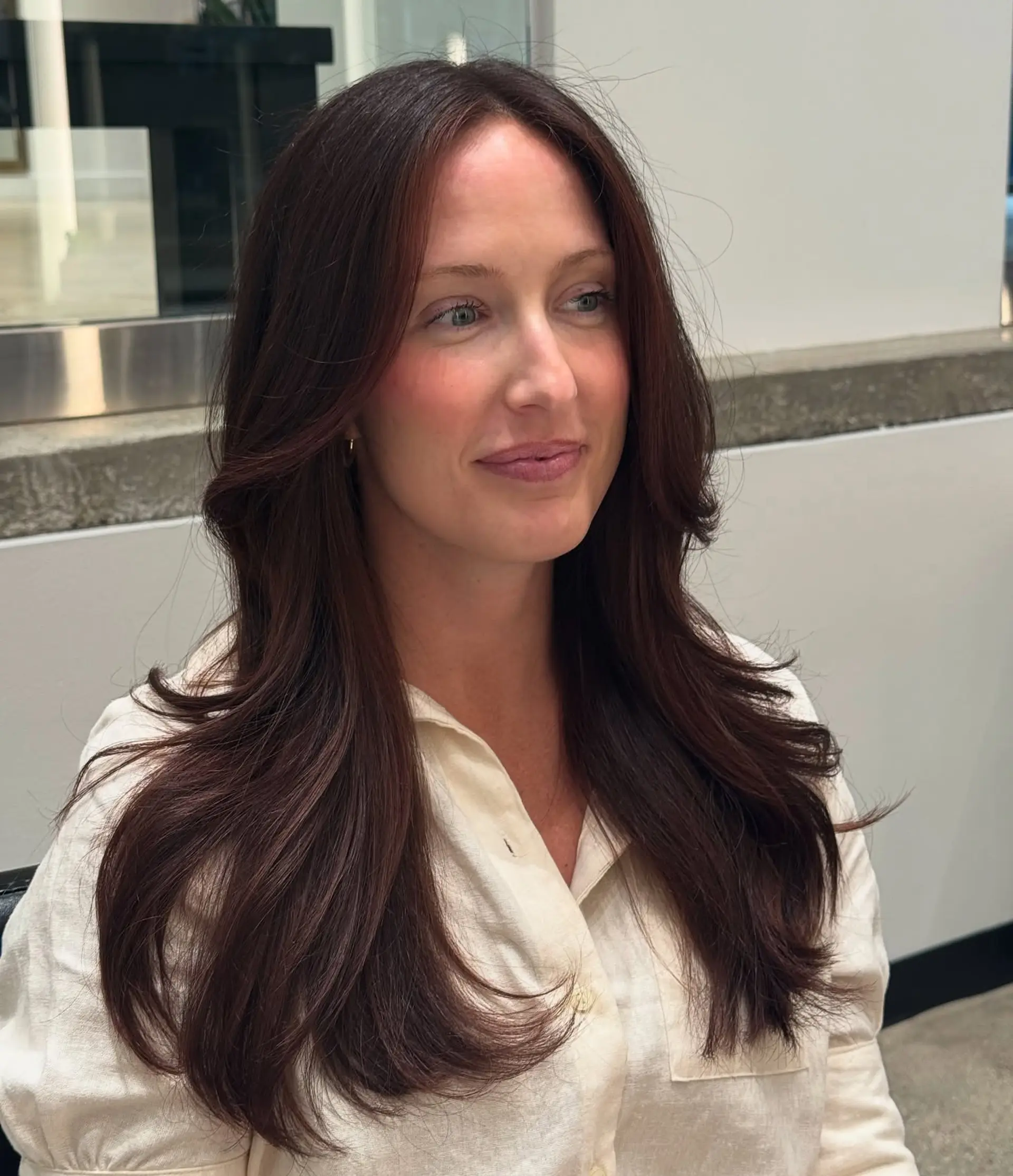 Long layered haircut with soft face-framing layers. 1