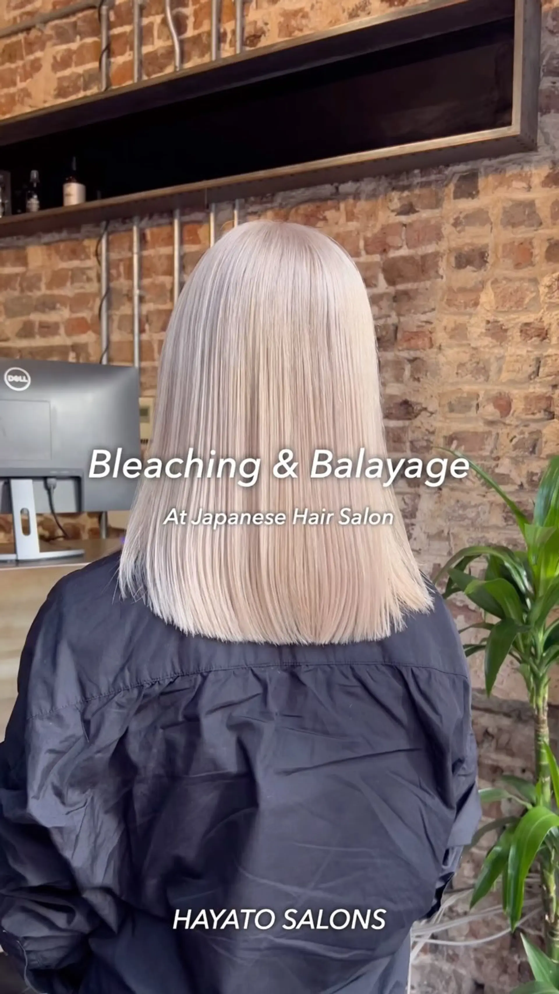 A sleek, straight shoulder-length blunt lob colored in an icy platinum blonde tone. 1