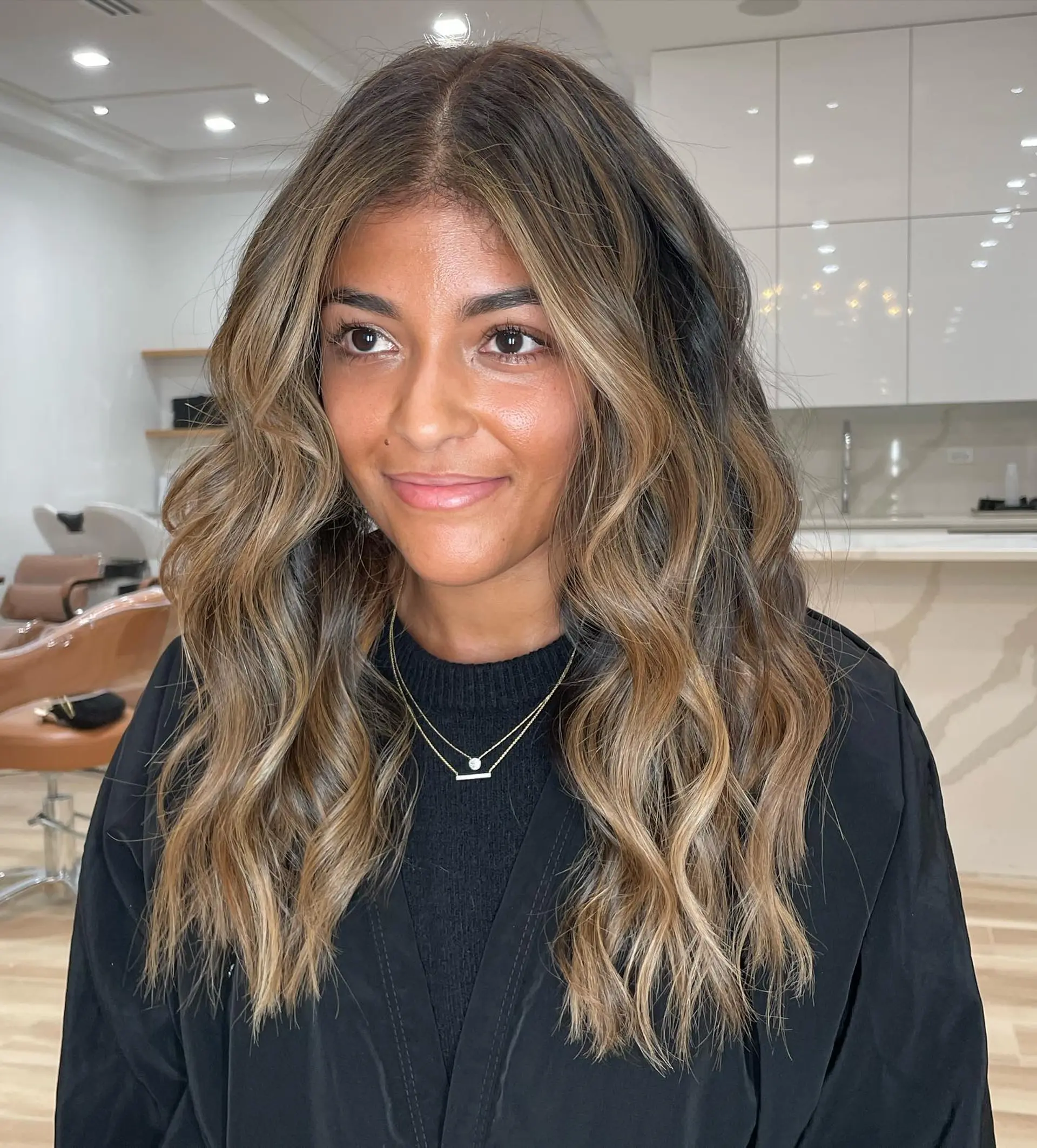 Long wavy brunette hair featuring dimensional honey and caramel balayage highlights with face-framing pieces. 1