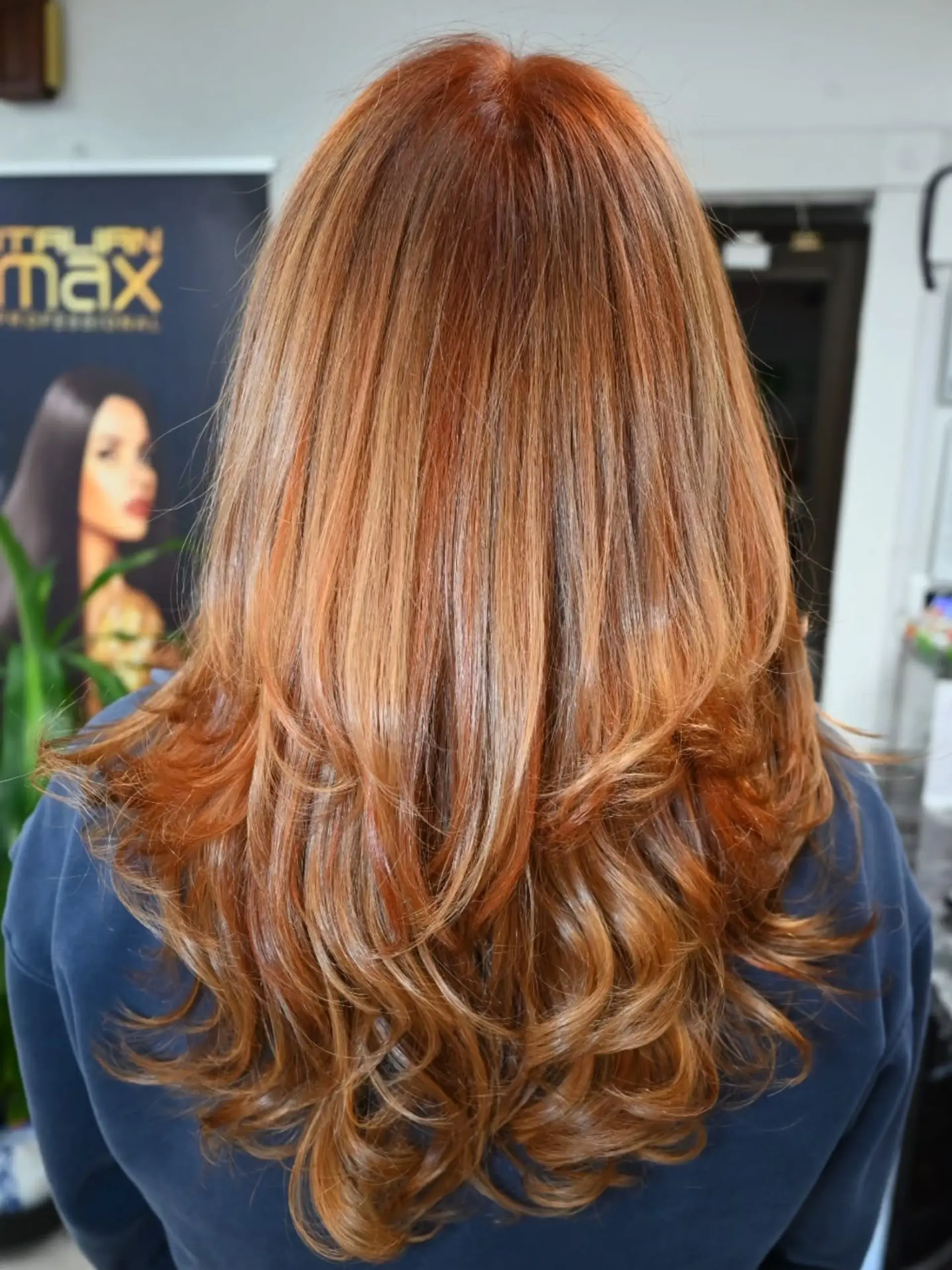 Long layered hair with a rich warm copper shade, golden blonde dimension, and styled curls at the ends. 1