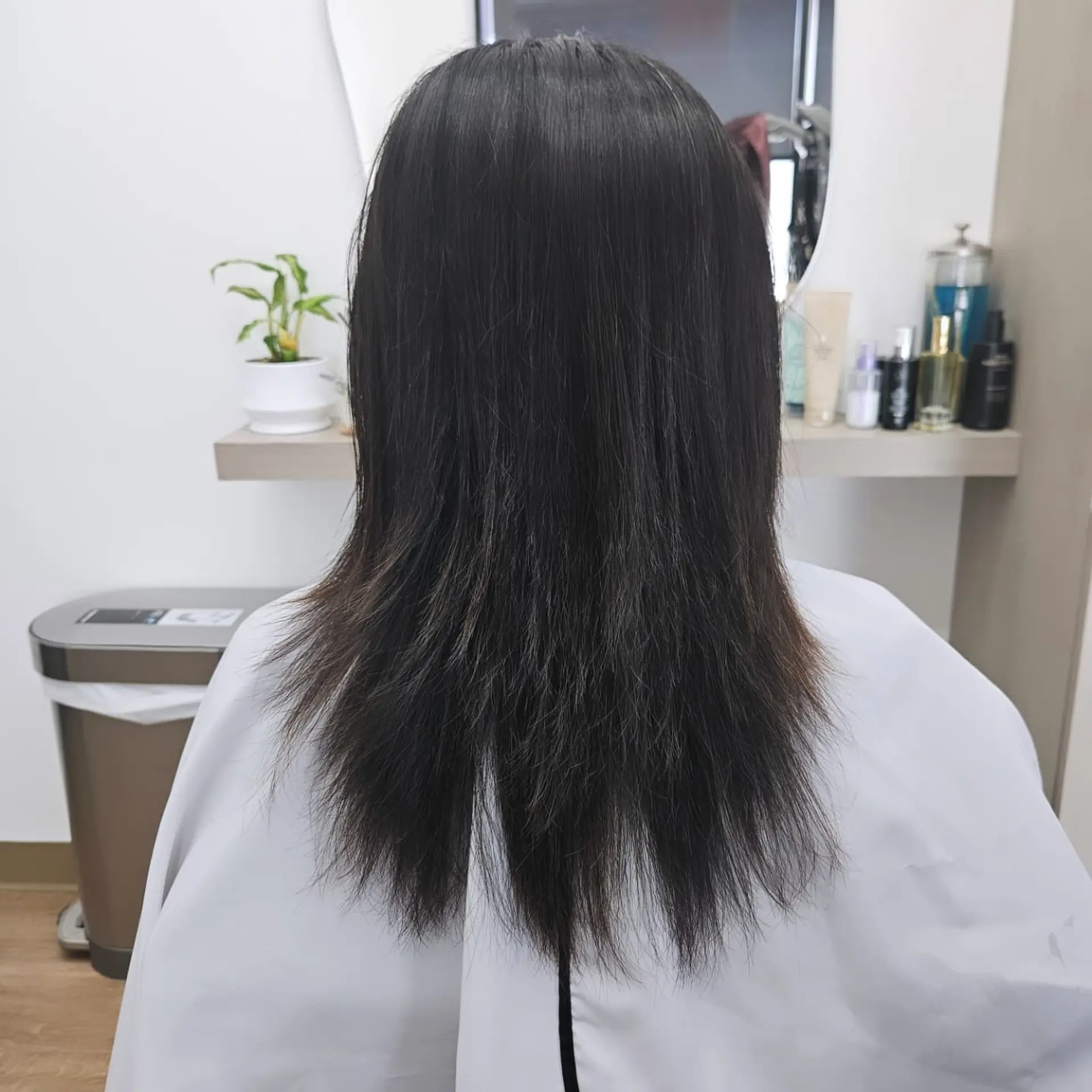 Medium-length straight dark hair featuring feathered, textured ends. 1
