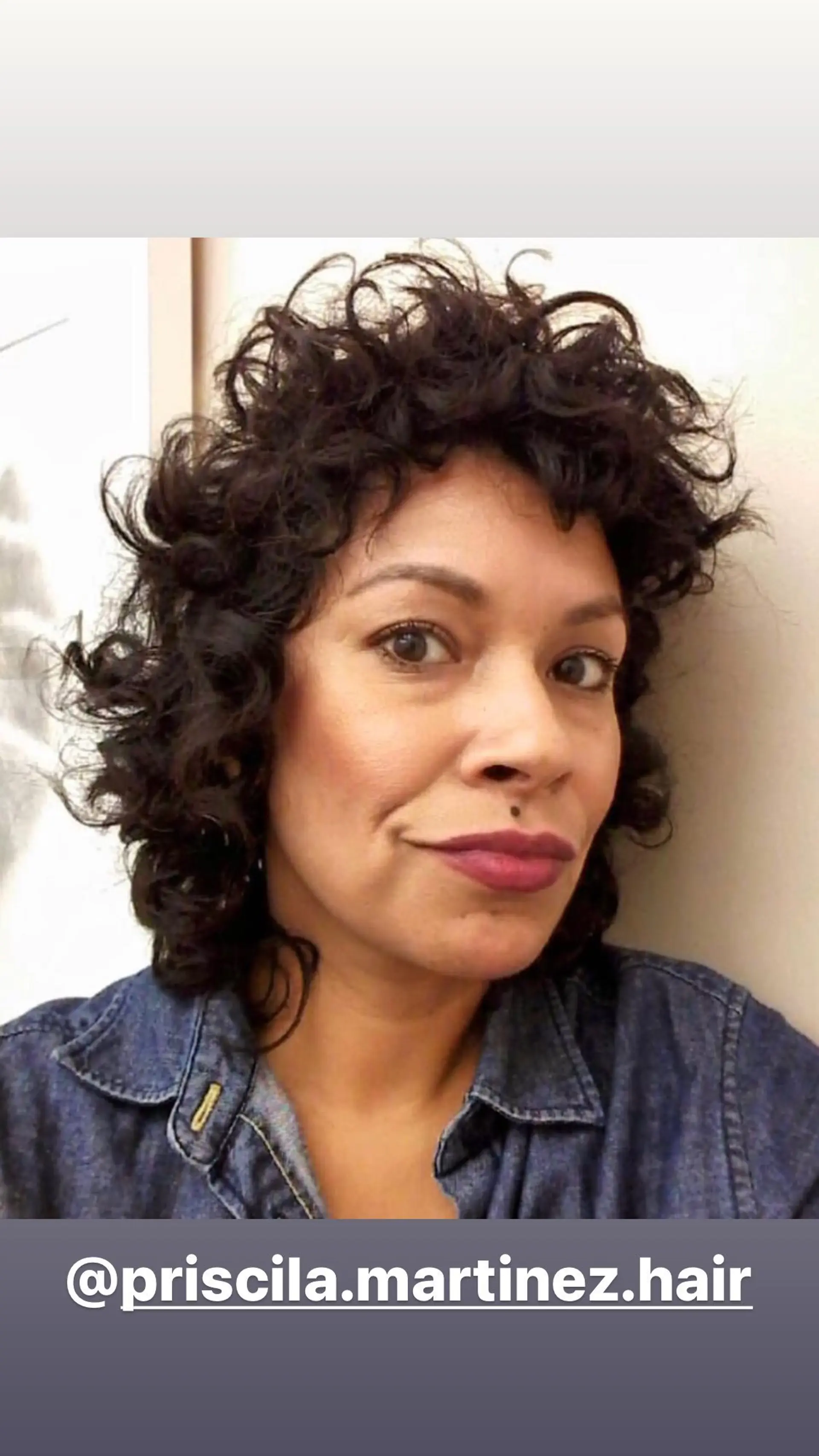 A short, textured curly bob with a curly fringe. 1