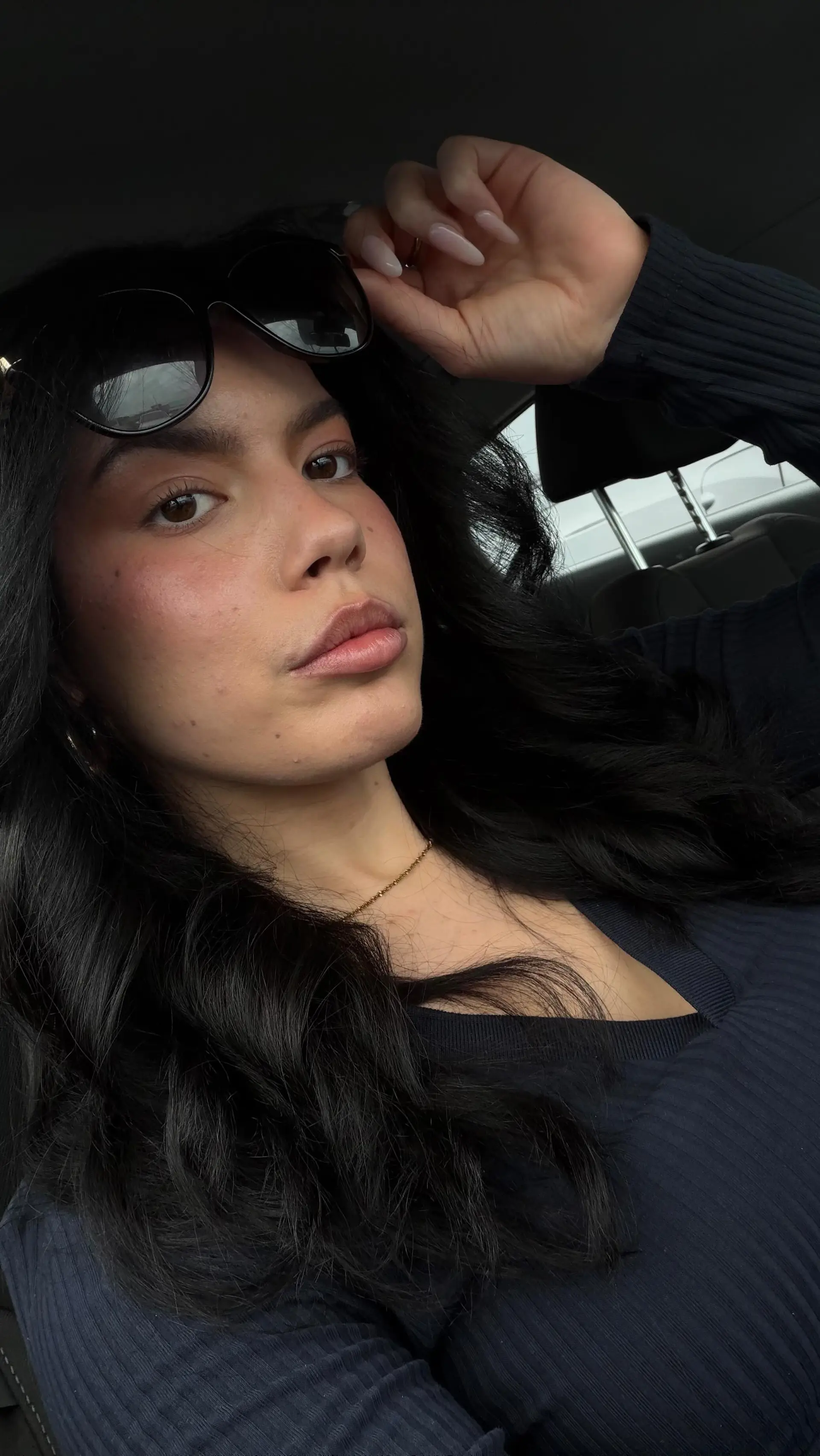 A glossy, voluminous dark blowout styled with soft waves and lifted roots. 1