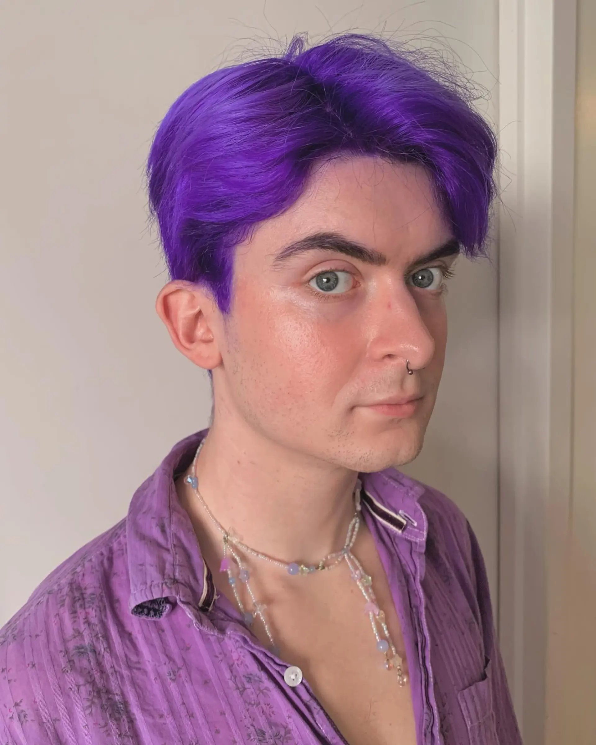 Vividly straight purple hair with a center part, short and playful, giving off an edgy and bold vibe, ideal for a trendy look. 4