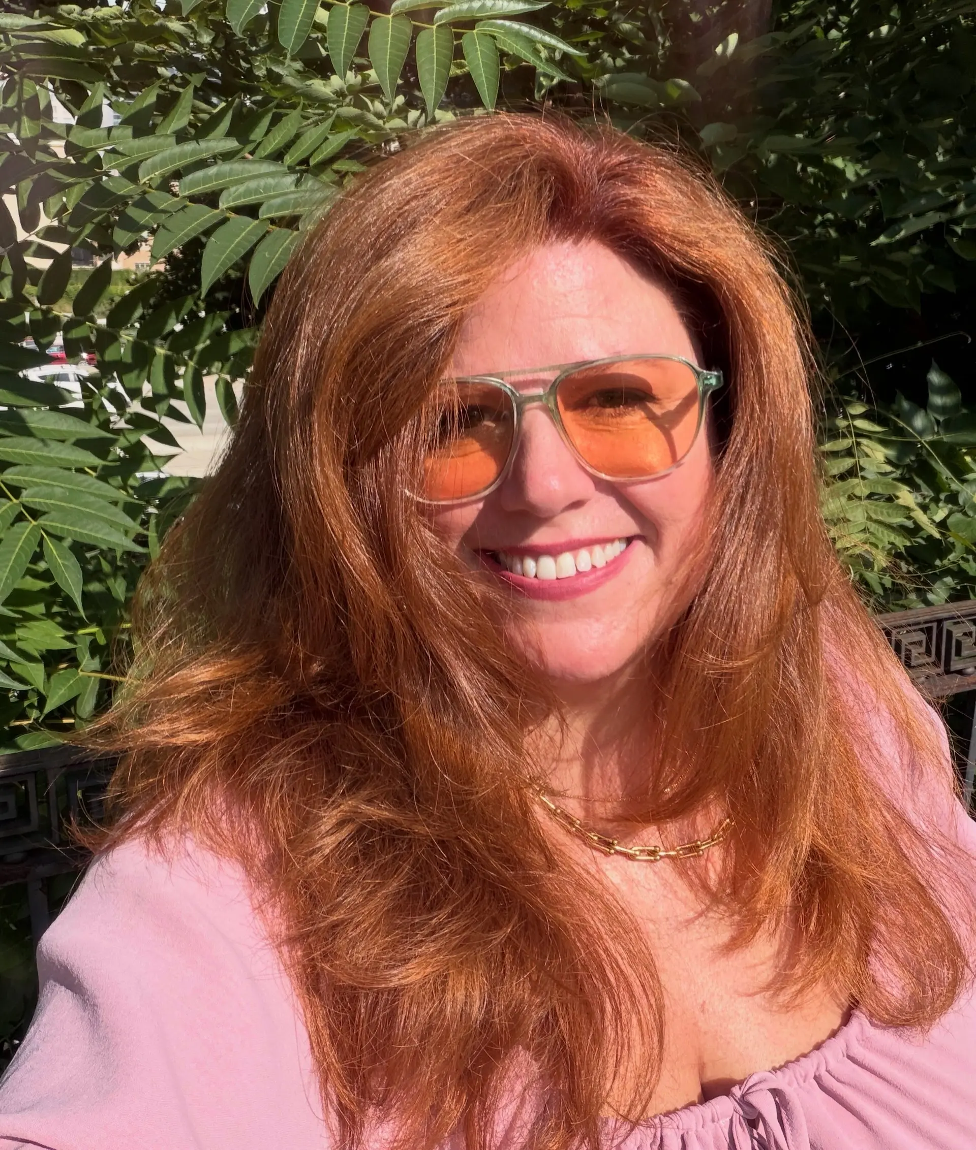 Rich, glowing copper-red hair cut with soft framing layers and styled into a voluminous blowout. 1