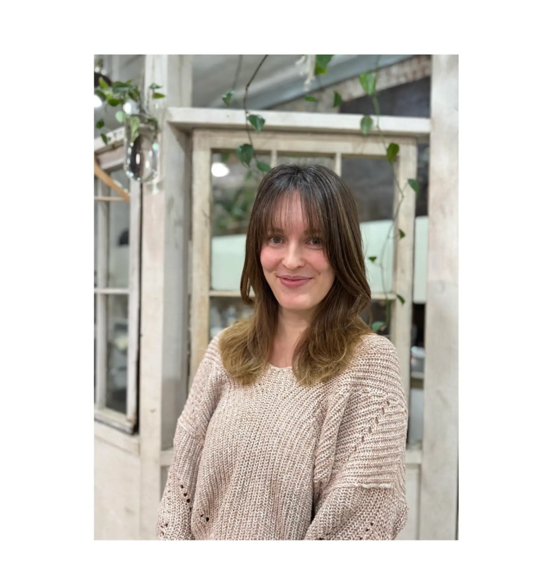 This hairstyle features curtain bangs and face-framing layers for a modern, easy-to-style look. 1