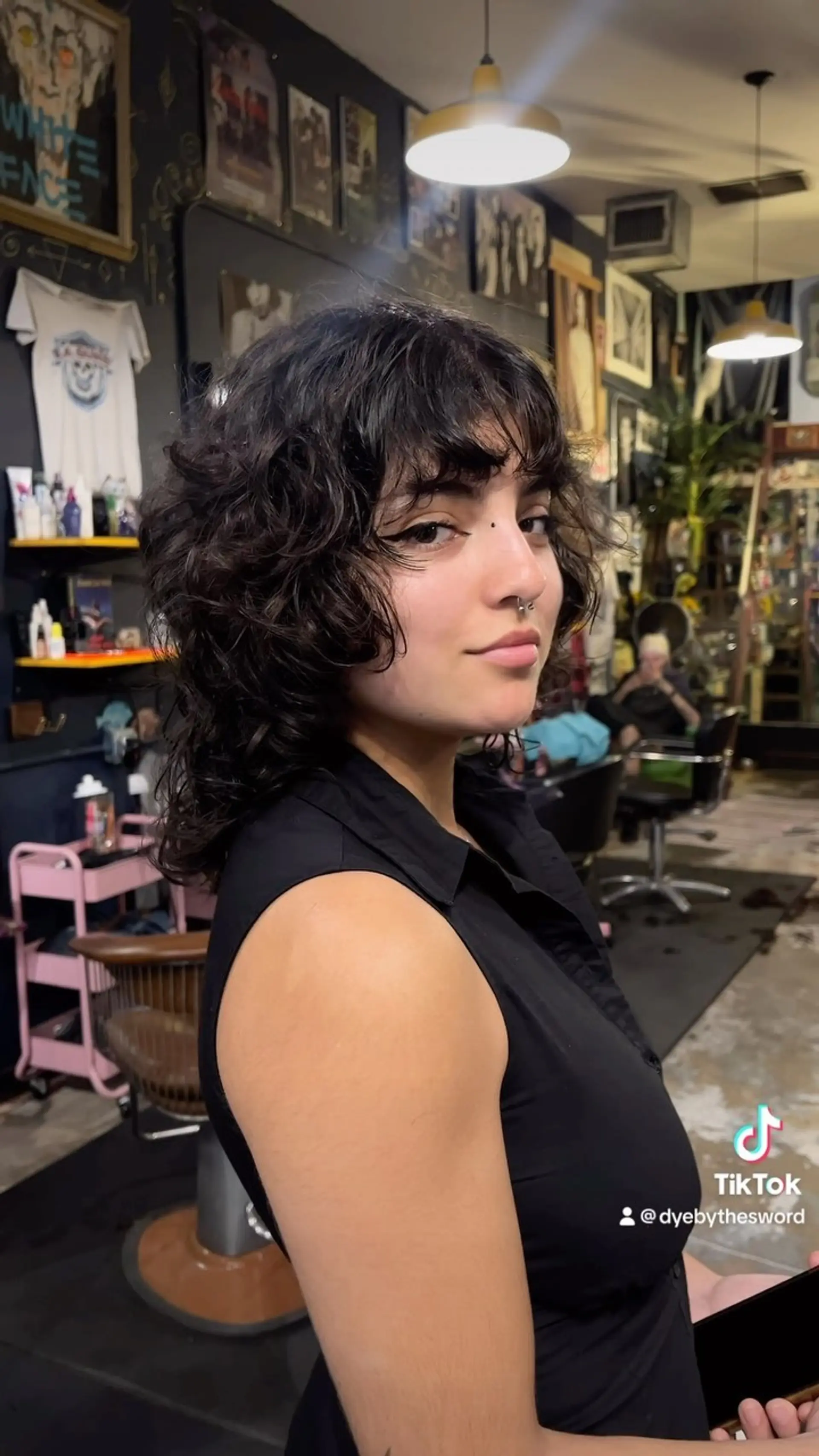 A medium-length textured shag haircut with choppy layers and full, face-framing bangs. 1