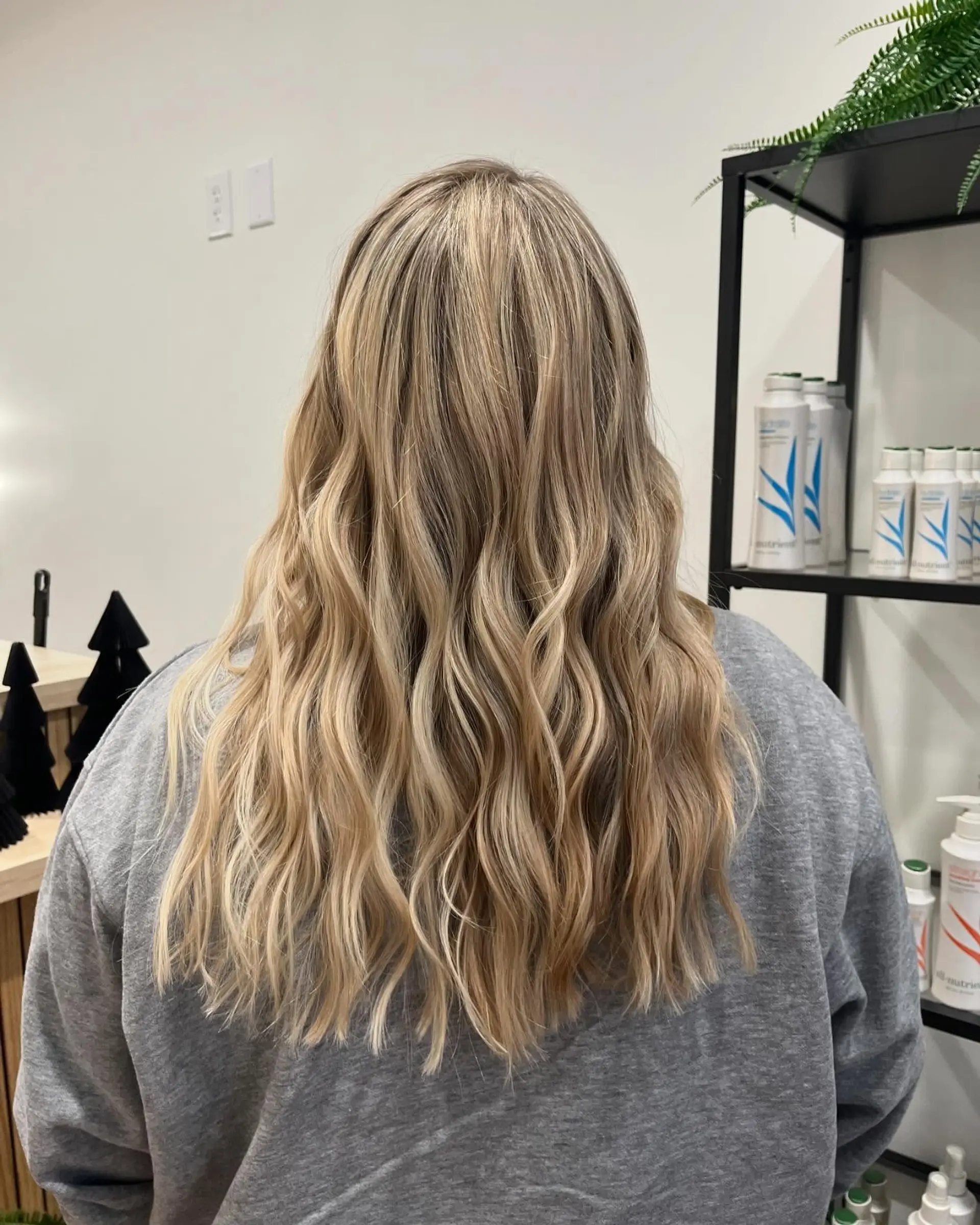 Long cool-toned blonde hair detailed with dimensional highlights and styled in soft, loose waves. 1