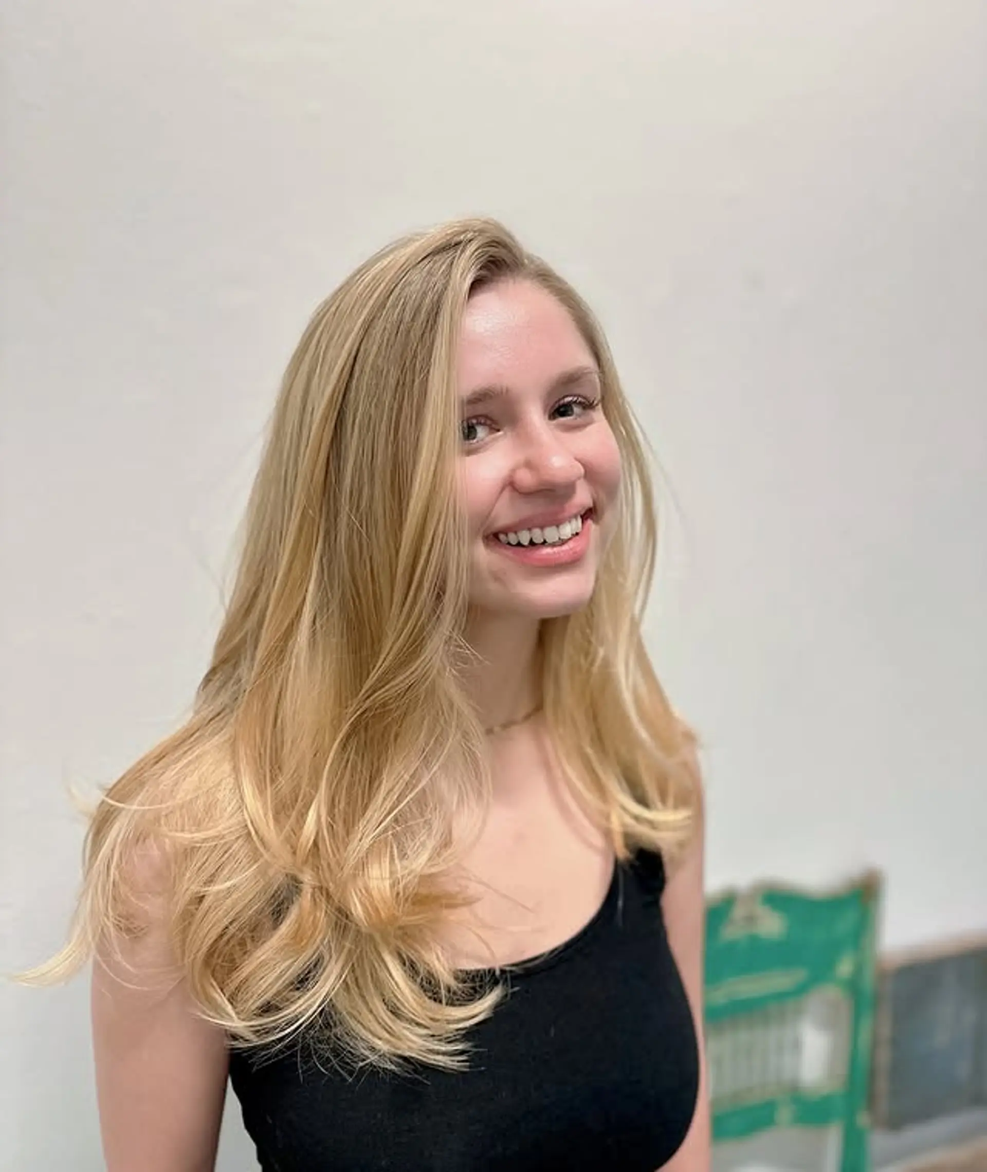 A long, layered hairstyle with a voluminous blowout and face-framing layers. 1