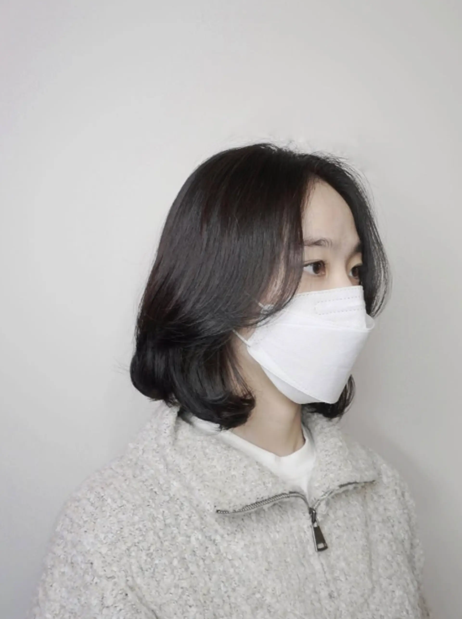 A chic layered bob with soft, face-framing bangs, this style offers a sleek and modern look. 1