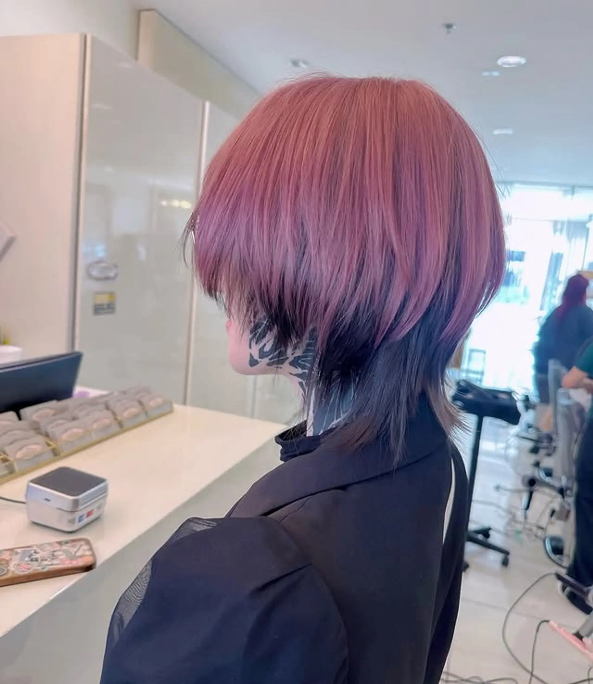 A stylish mullet with a blend of pink and black shadow roots. 1