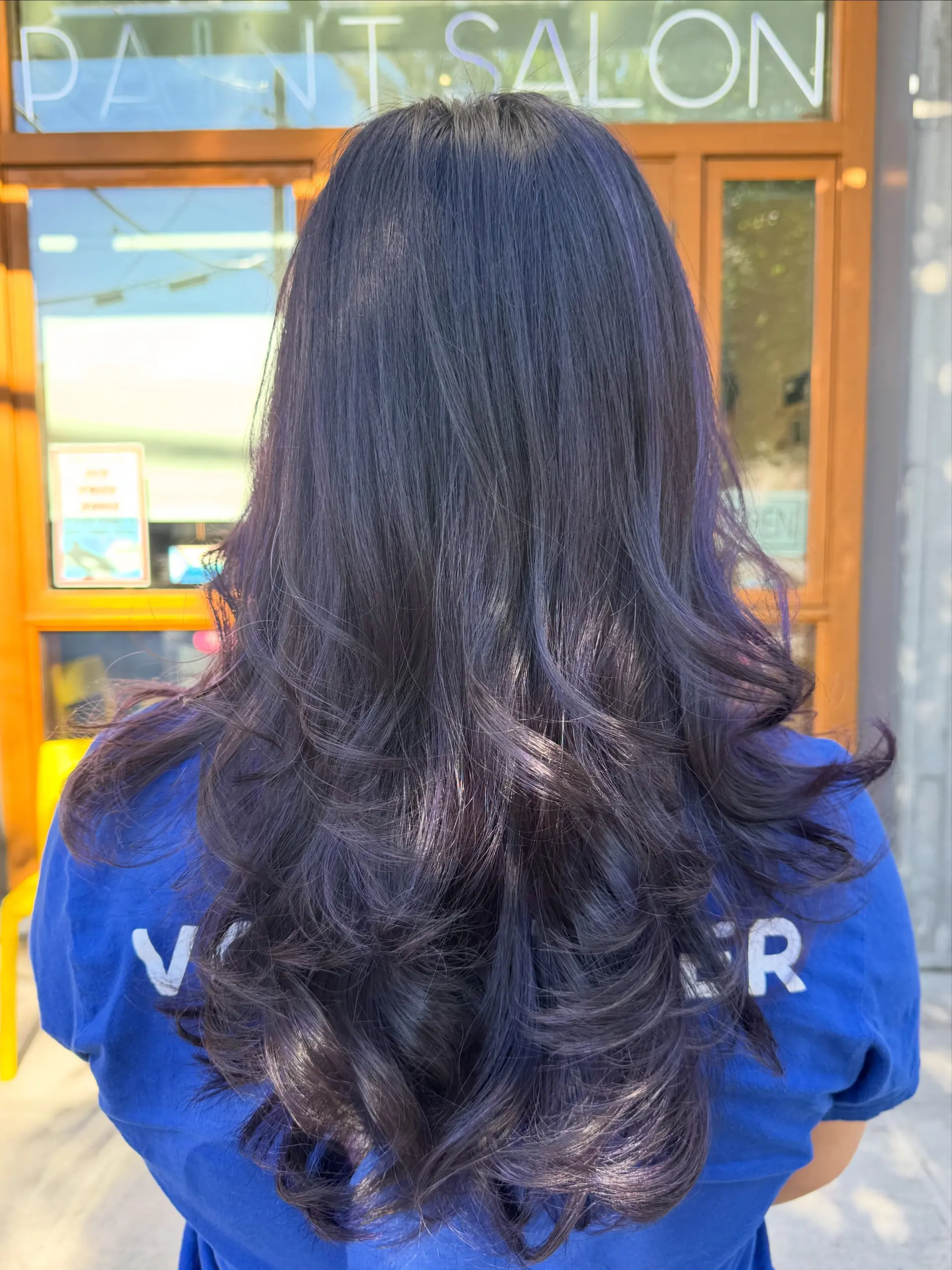 Long deep purple hair styled with soft, voluminous layered waves. 1