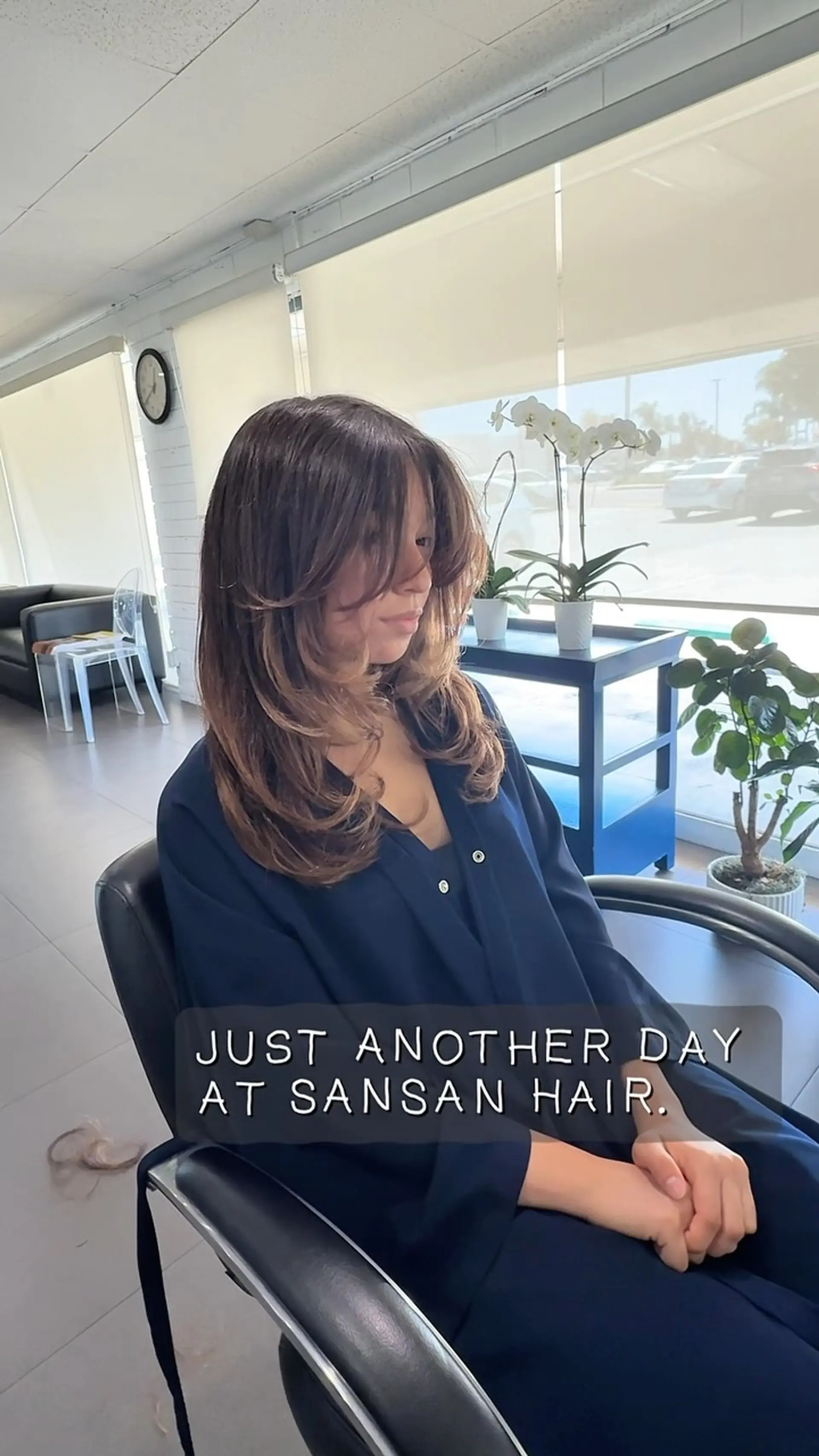 A long layered haircut featuring rounded, face-framing curtain bangs and voluminous inward-curled ends. 1