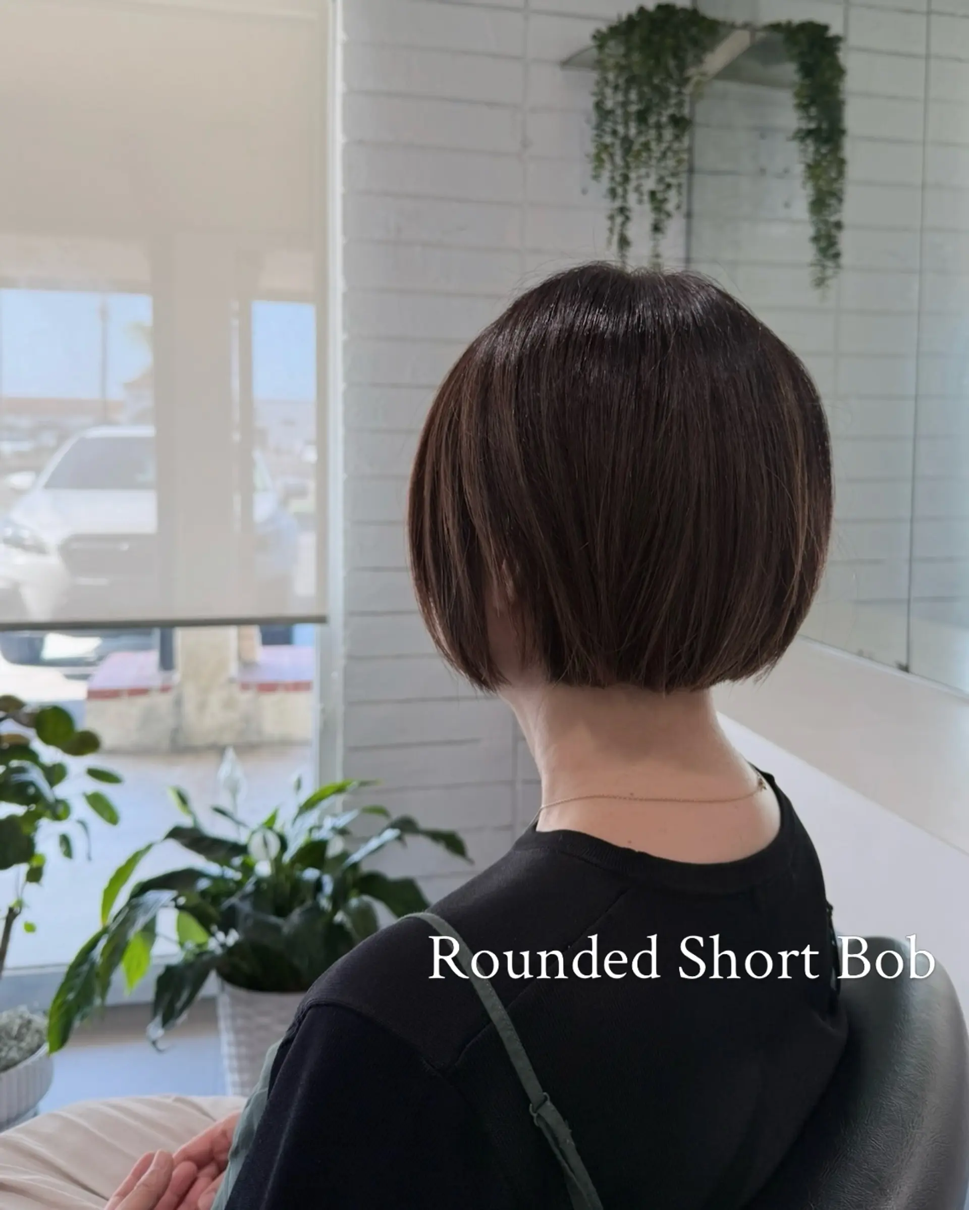 A sleek, rounded short bob with subtle graduation creating volume at the back and a clean, straight perimeter above the nape. 1