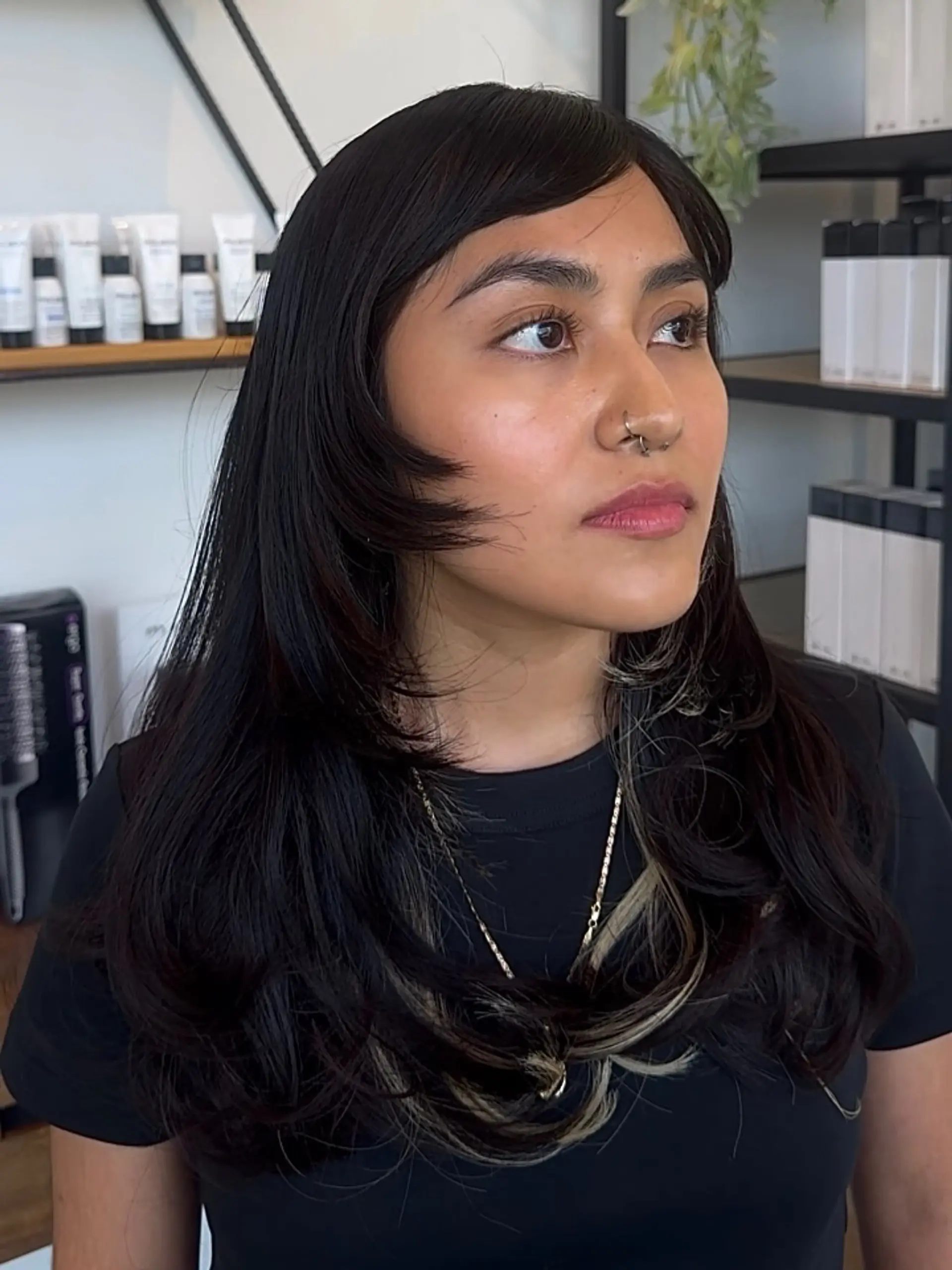 Long dark black hair with side bangs, face-framing layers, and blonde peekaboo highlights. 1