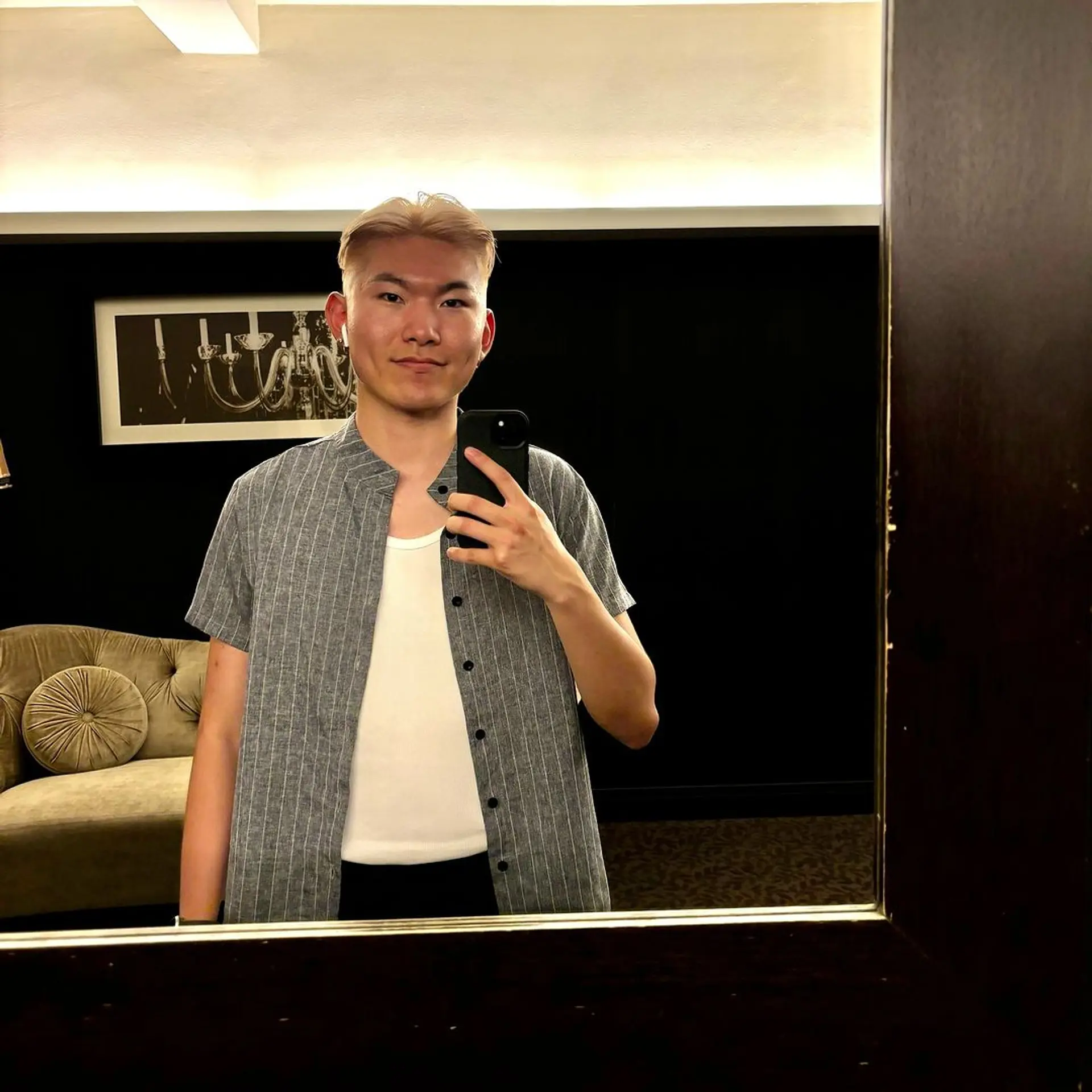 A hairstyle with a short length, platinum blonde color, straight texture, featuring an undercut and textured top with a side part. 1