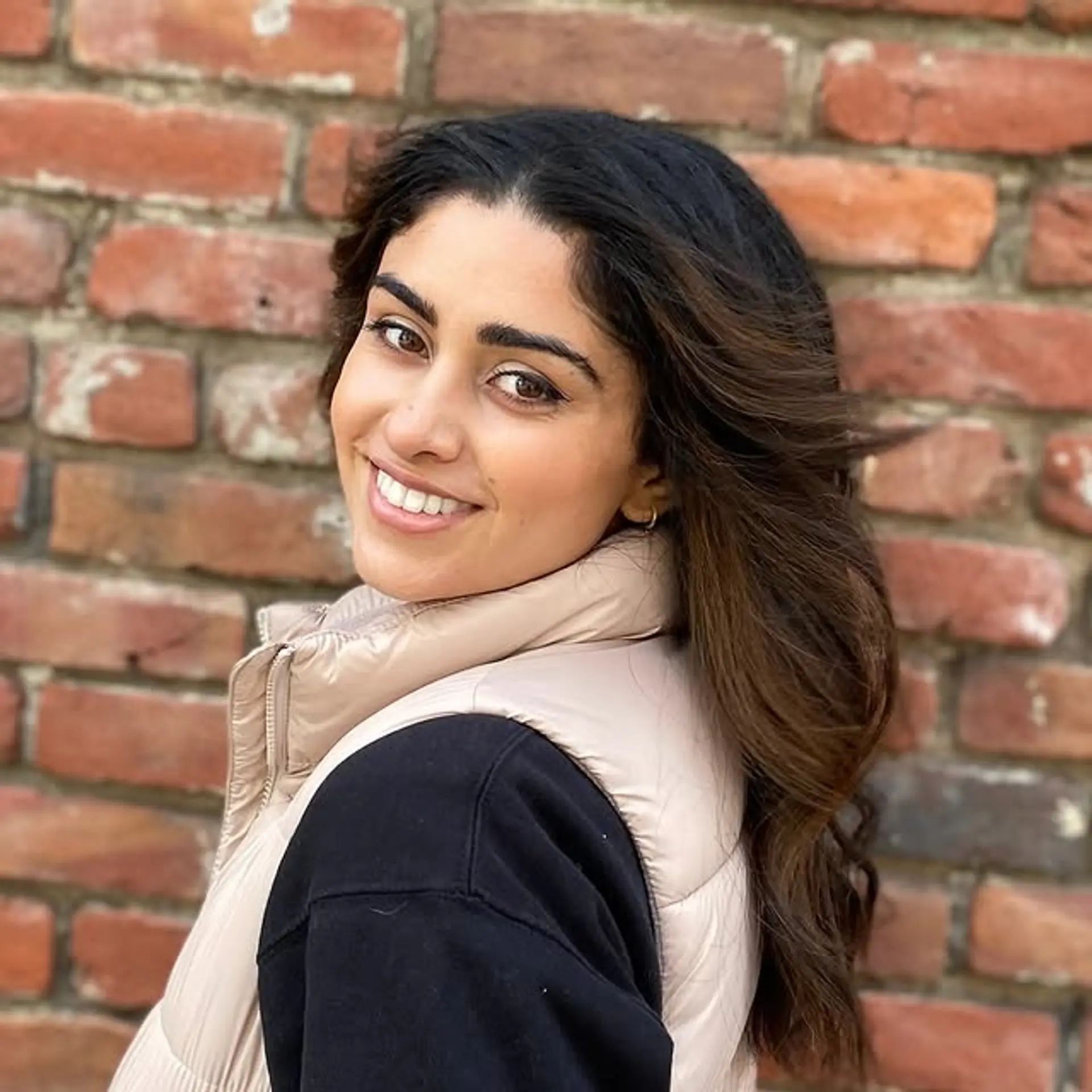 A medium-length layered hairstyle styled in a blowout for volume and movement. 1