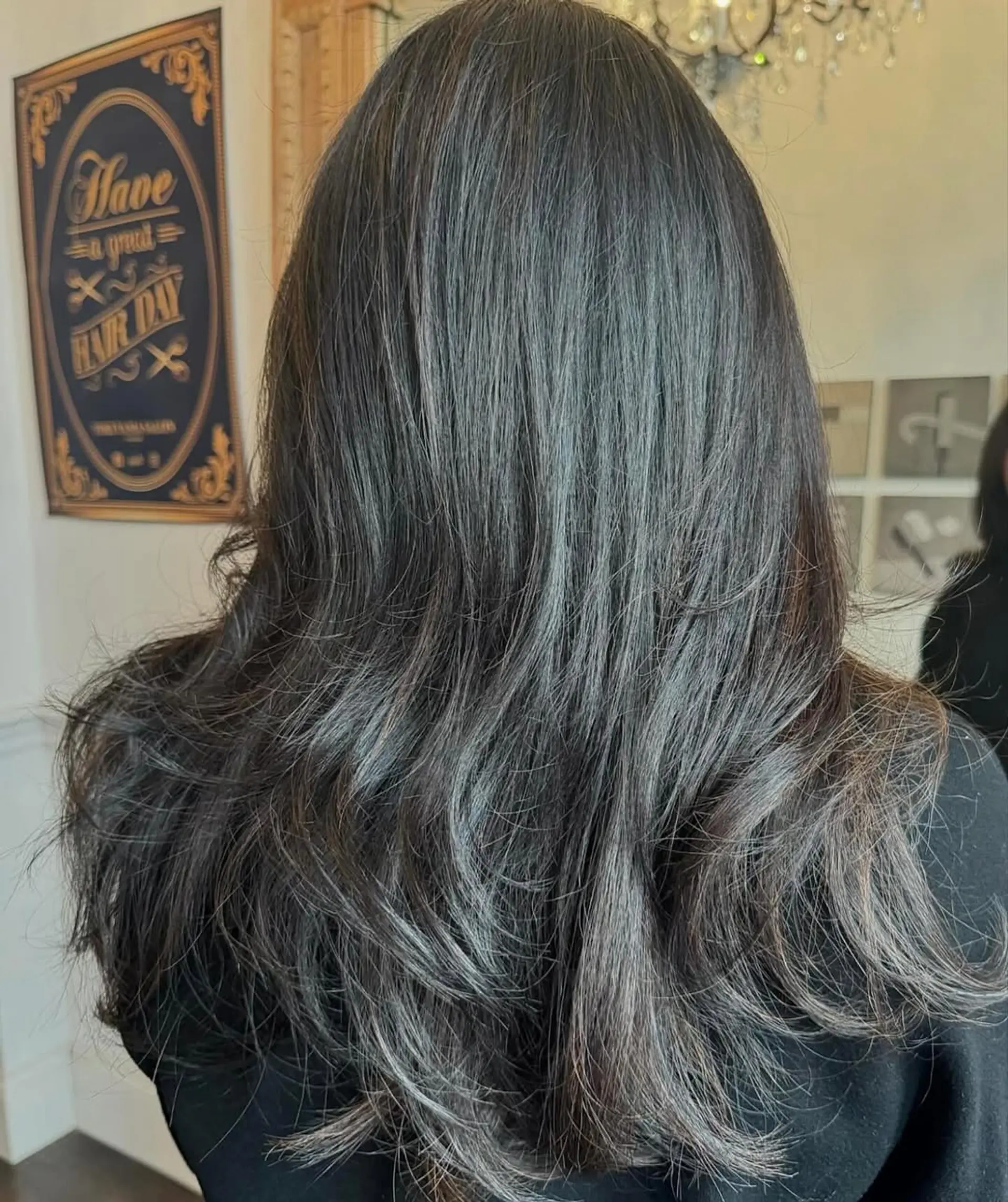 Luxurious long, wavy black hair with soft waves, natural sheen, and layered ends for elegant movement. 1