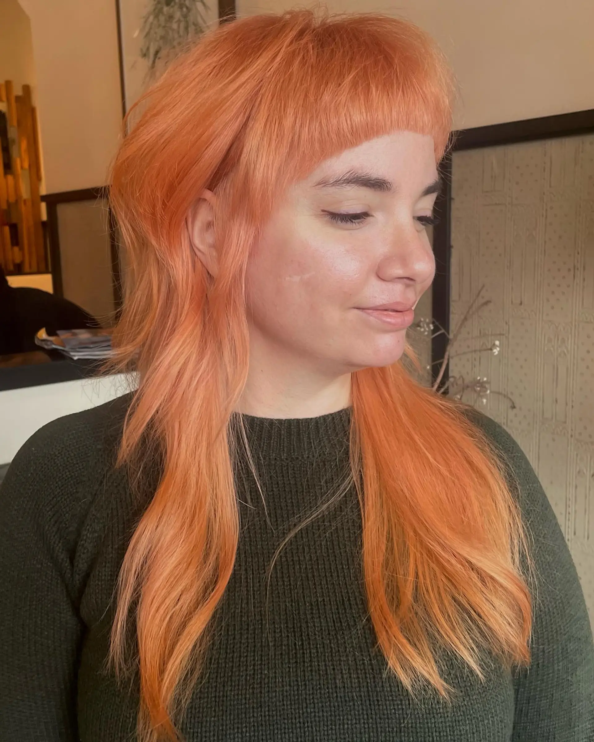 A modern punk mullet featuring short baby bangs and layered sides. 1