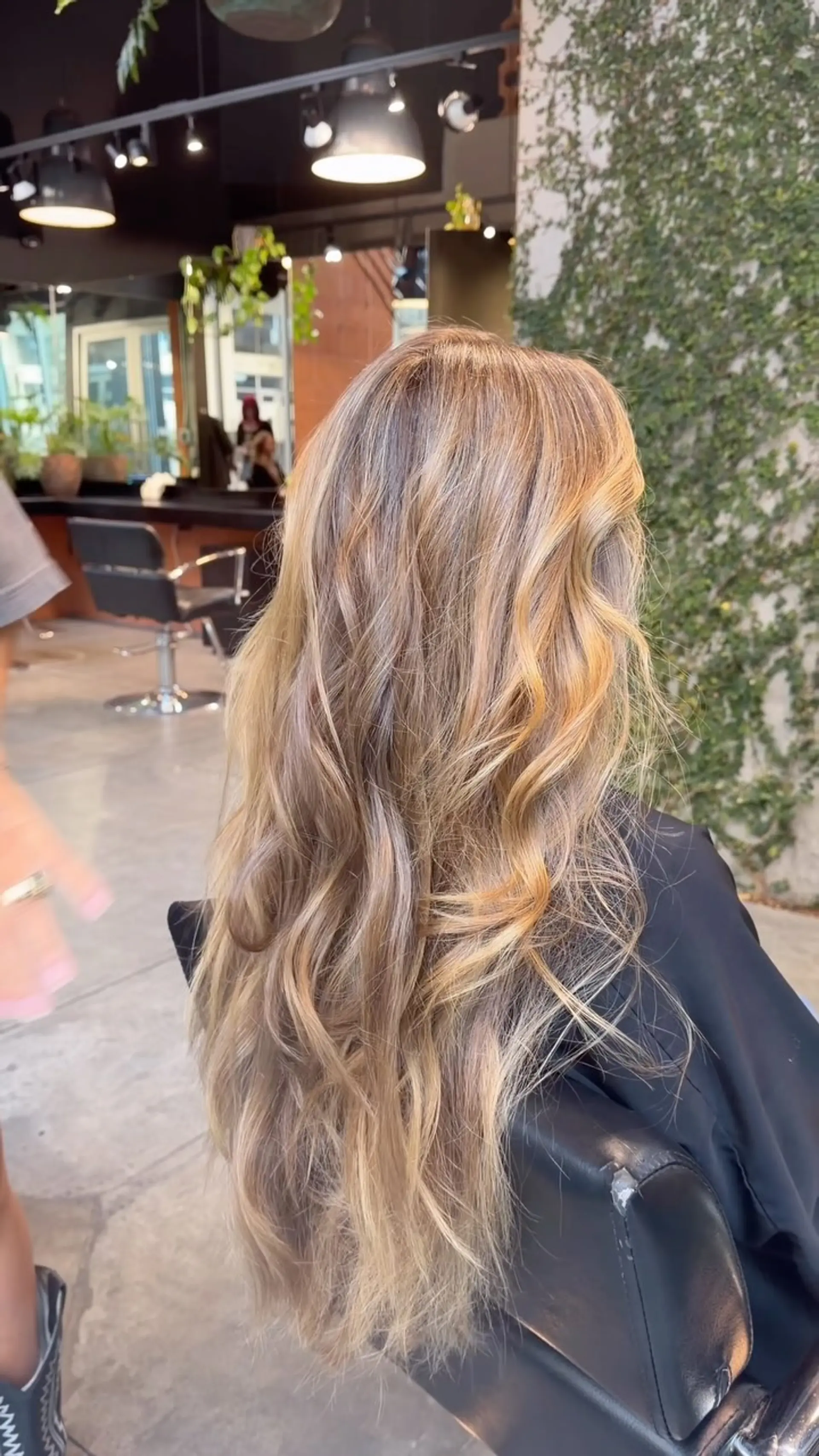 Long hair featuring a multi-dimensional warm blonde balayage styled in soft, loose waves. 1