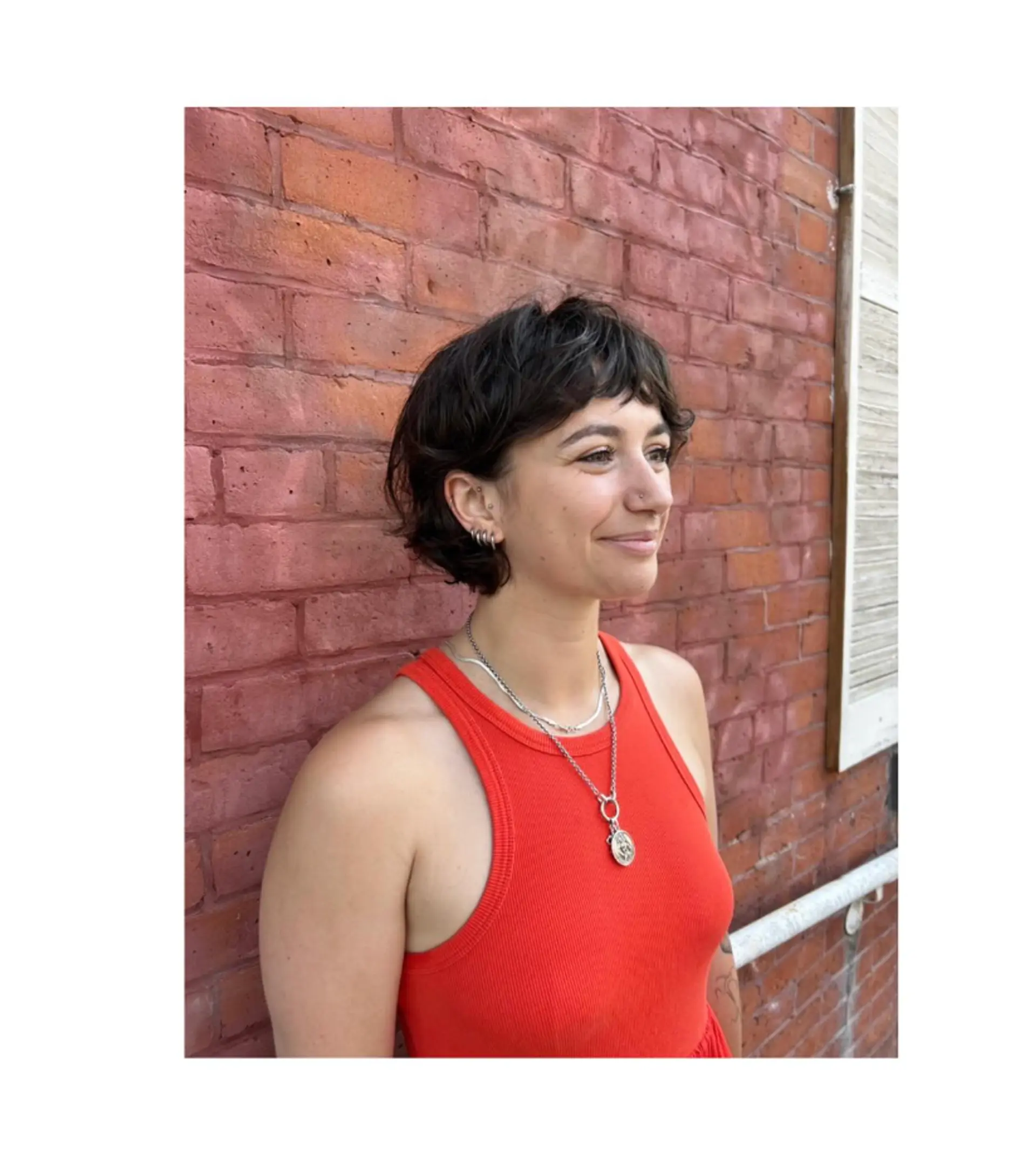 A short, shaggy pixie cut with textured layers and bangs. 1
