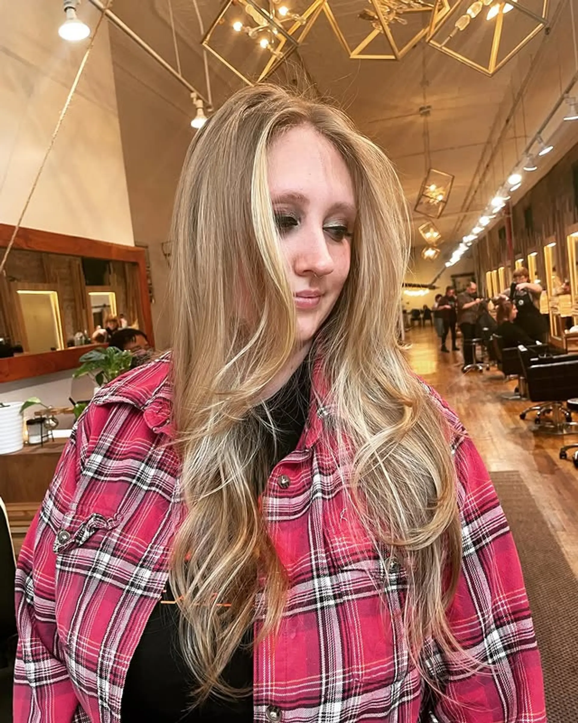 Long layered haircut with a blonde balayage and face-framing layers. 1