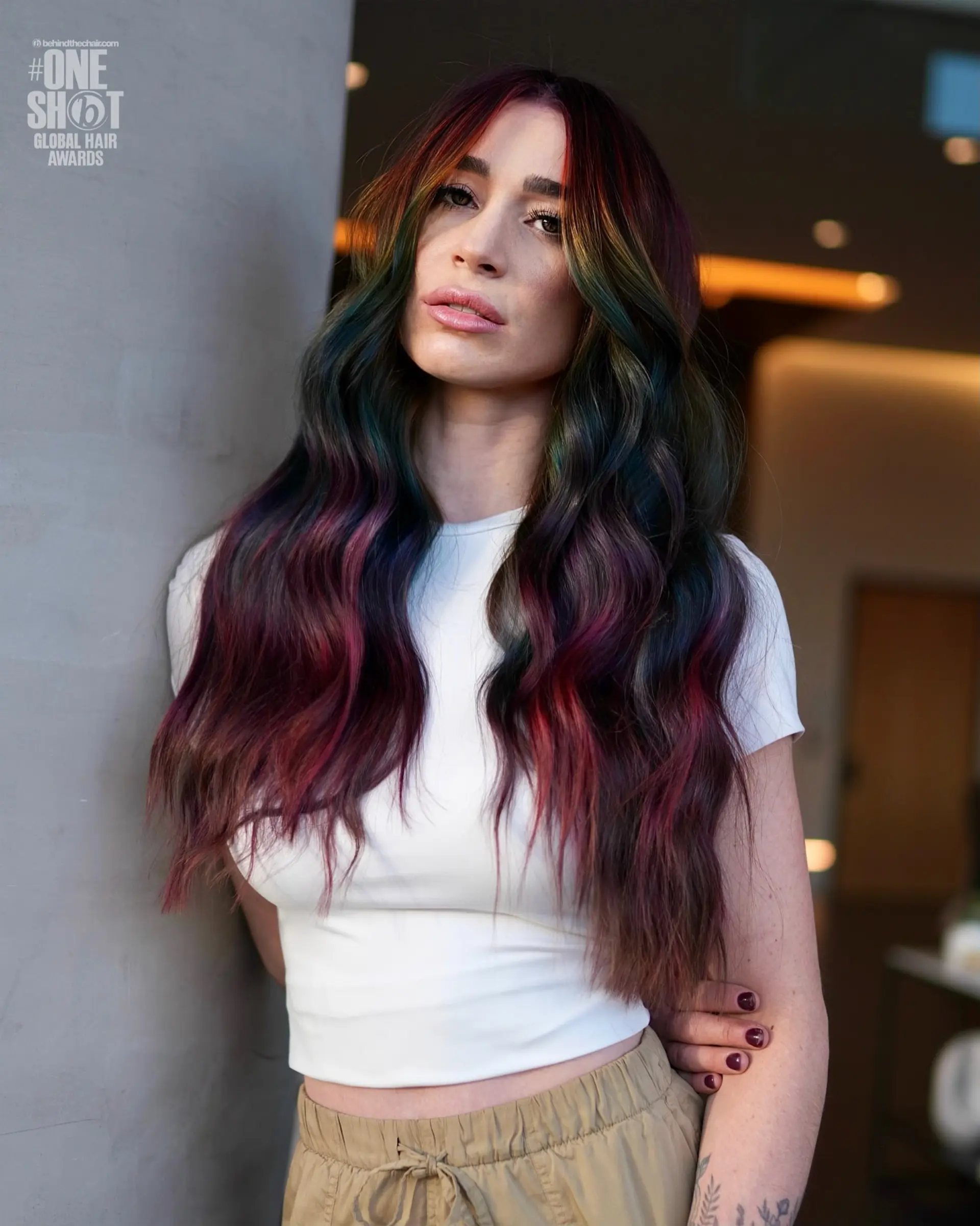 Long, dark wavy hair accented with vibrant jewel-toned vivid panels in purple, magenta, teal green, and blue. 1