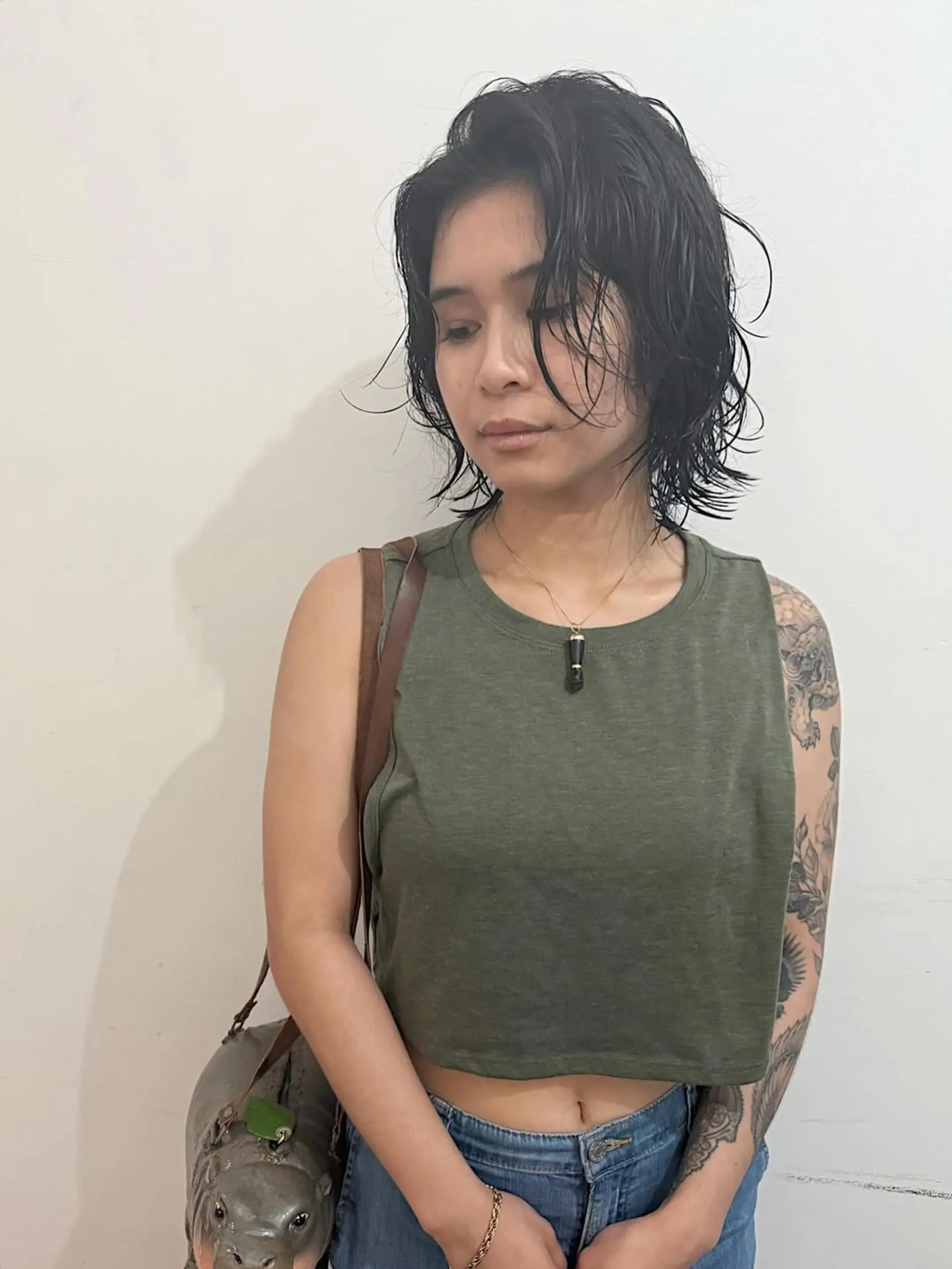 A modern and edgy short shag bob, characterized by its voluminous layers and textured finish. This cut is designed to highlight natural waves and create an effortlessly cool, lived-in feel. 1