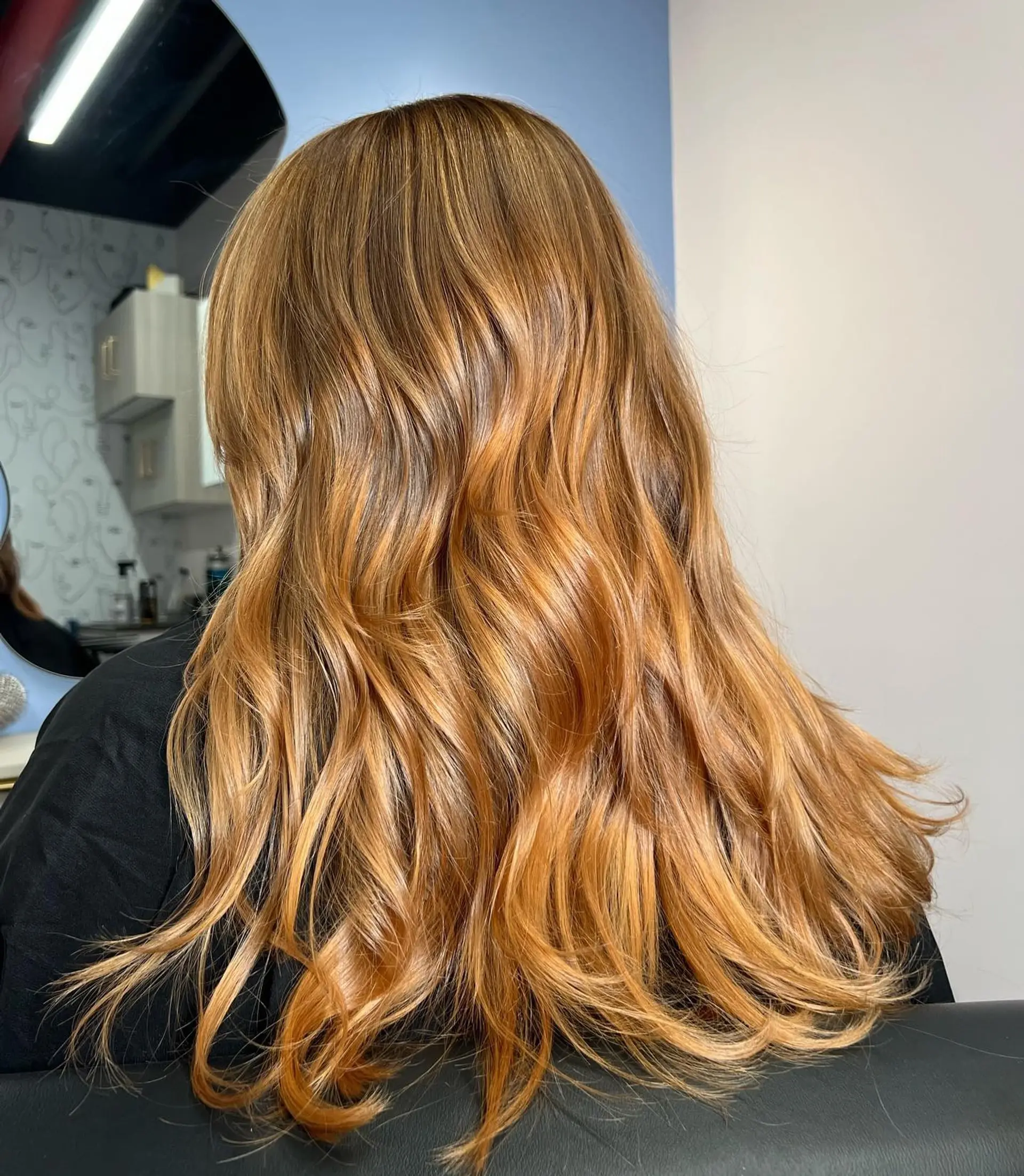 Long, wavy hair with a copper base and blonde balayage highlights. 1