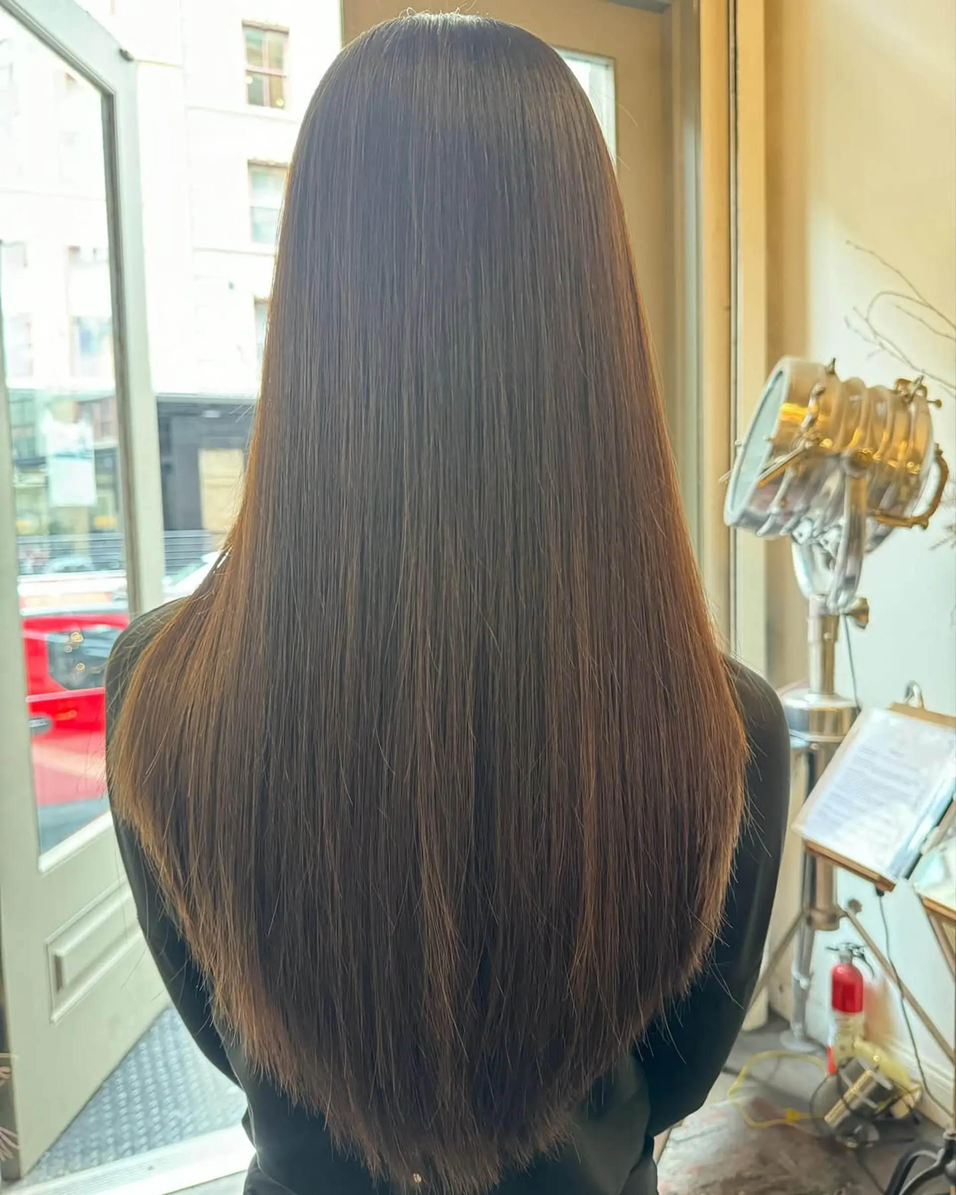 Extremely straight, very long dark brown hair with ultra-smooth, silky texture and minimal layers, giving a sleek and elegant appearance. 2