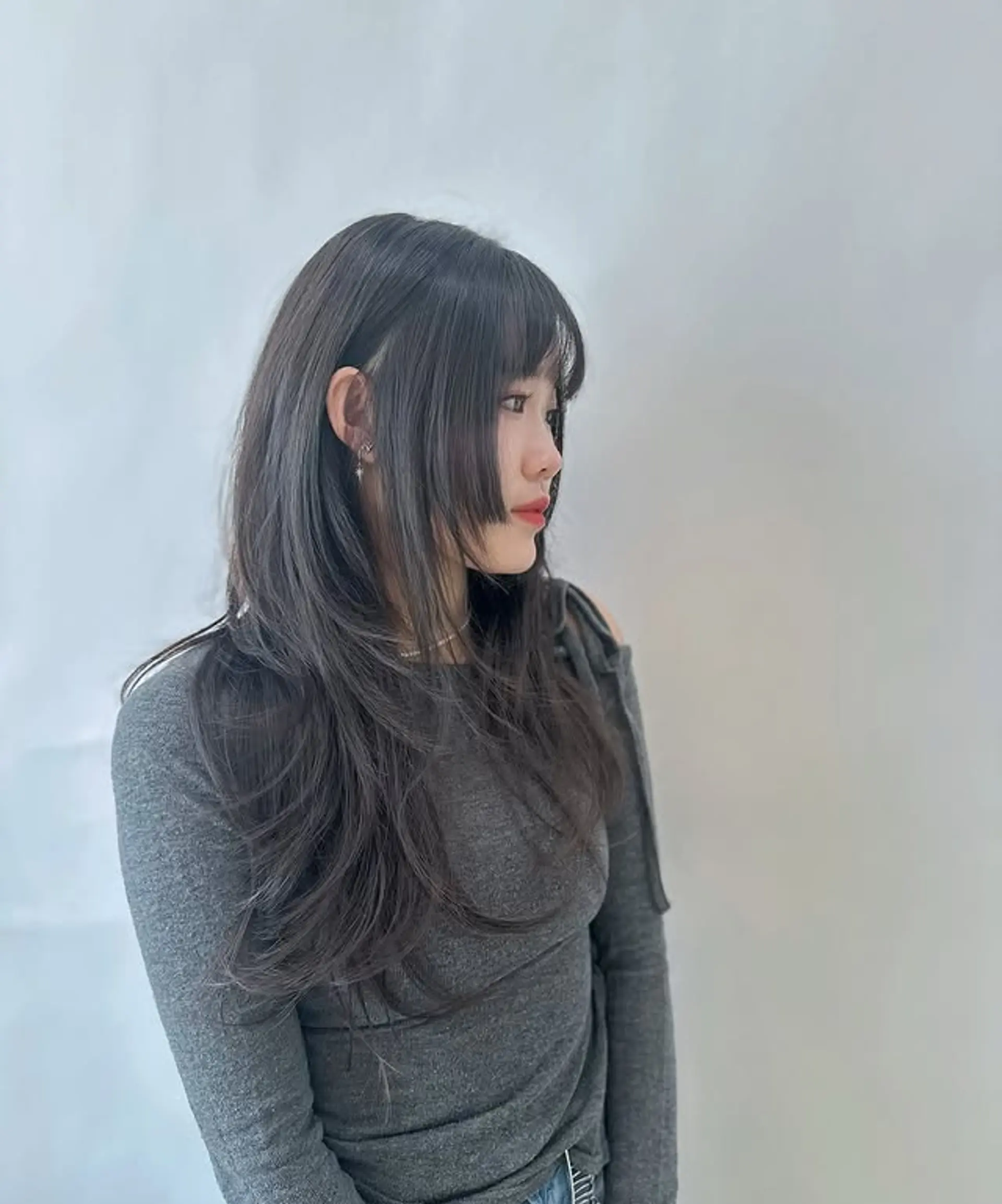 A modern and edgy wolf cut with face-framing layers and see-through bangs. 1