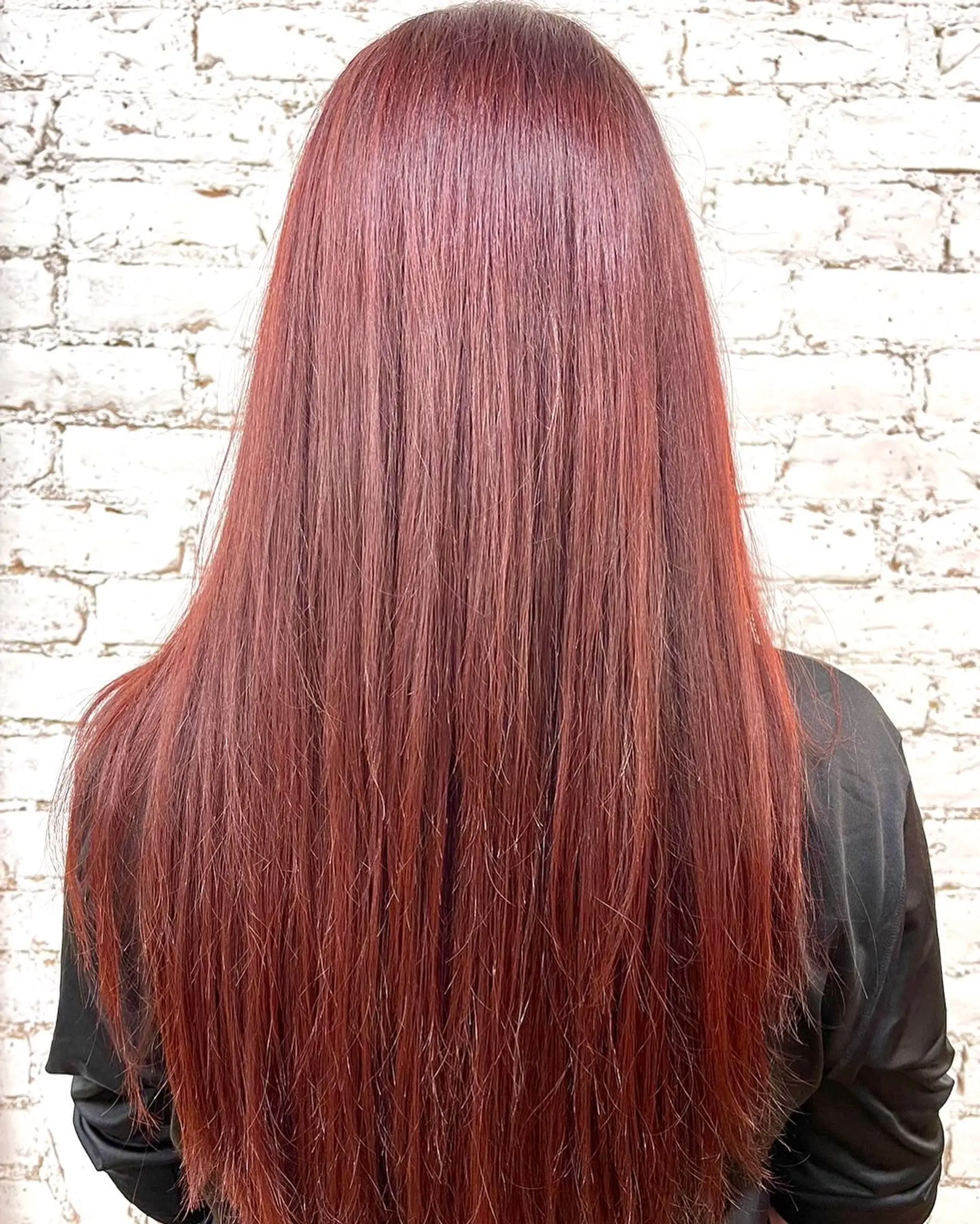 Long, sleek straight hair colored in a vibrant, shiny auburn red tone. 1