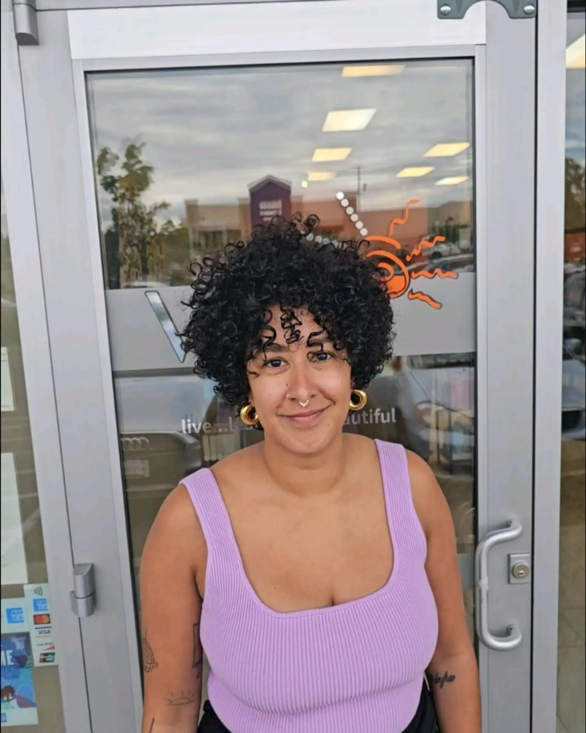 A rounded short curly haircut styled with defined ringlets and face-framing curly bangs. 1