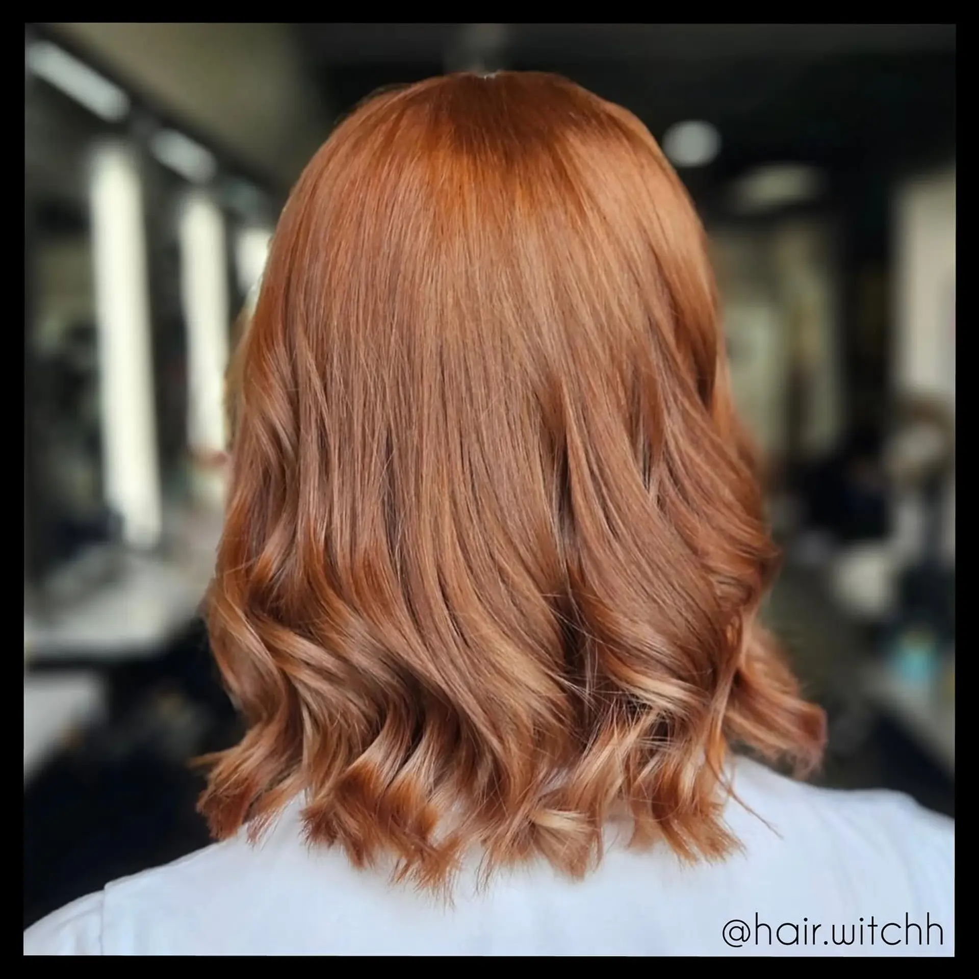 Collarbone-length warm copper lob with soft, loose waves and textured ends. 1