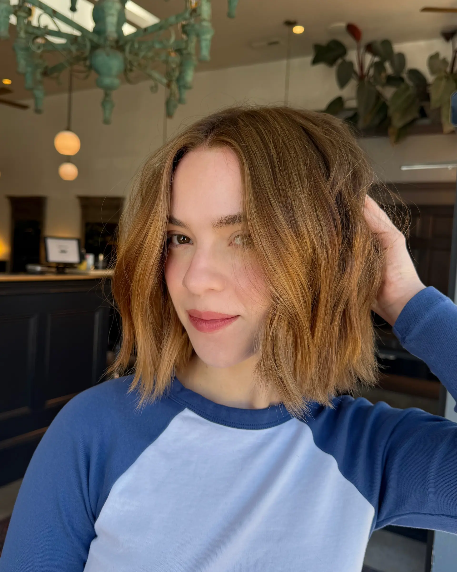 A blunt, textured bob with tousled, effortless waves and warm dimensional honey tones. 1