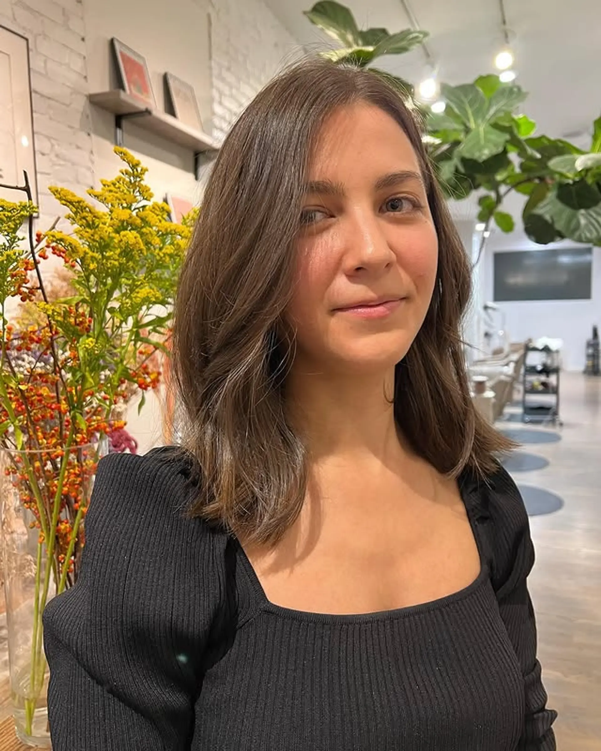 A medium-length layered cut with soft waves and face-framing layers. 1