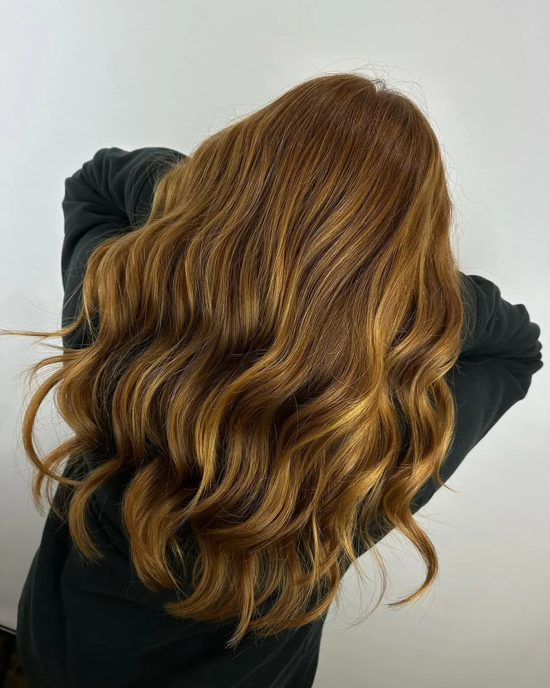 Long hair with a warm caramel balayage and soft waves. 1