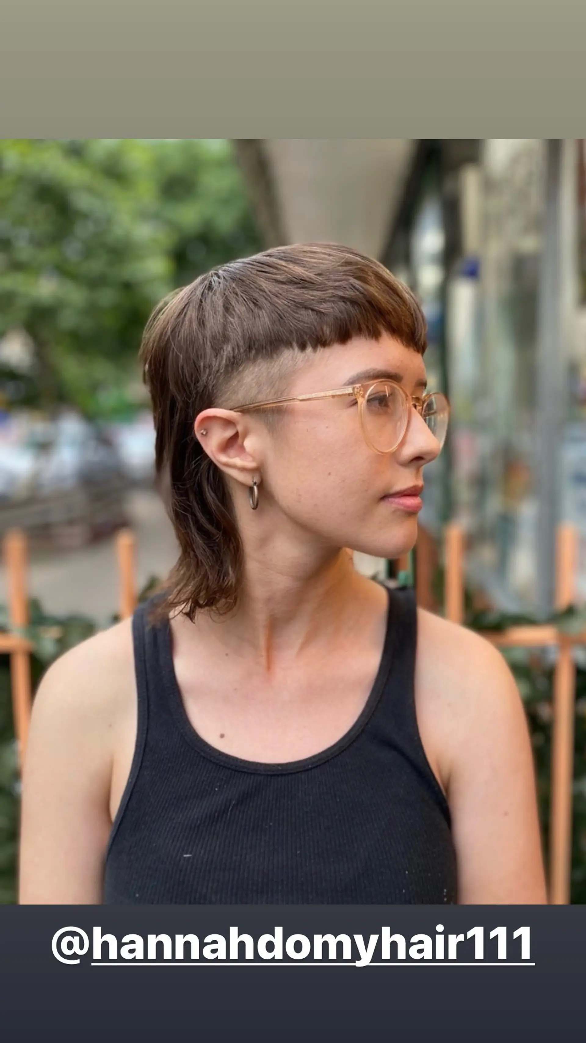 A stylish mullet with an undercut and short baby bangs. 1