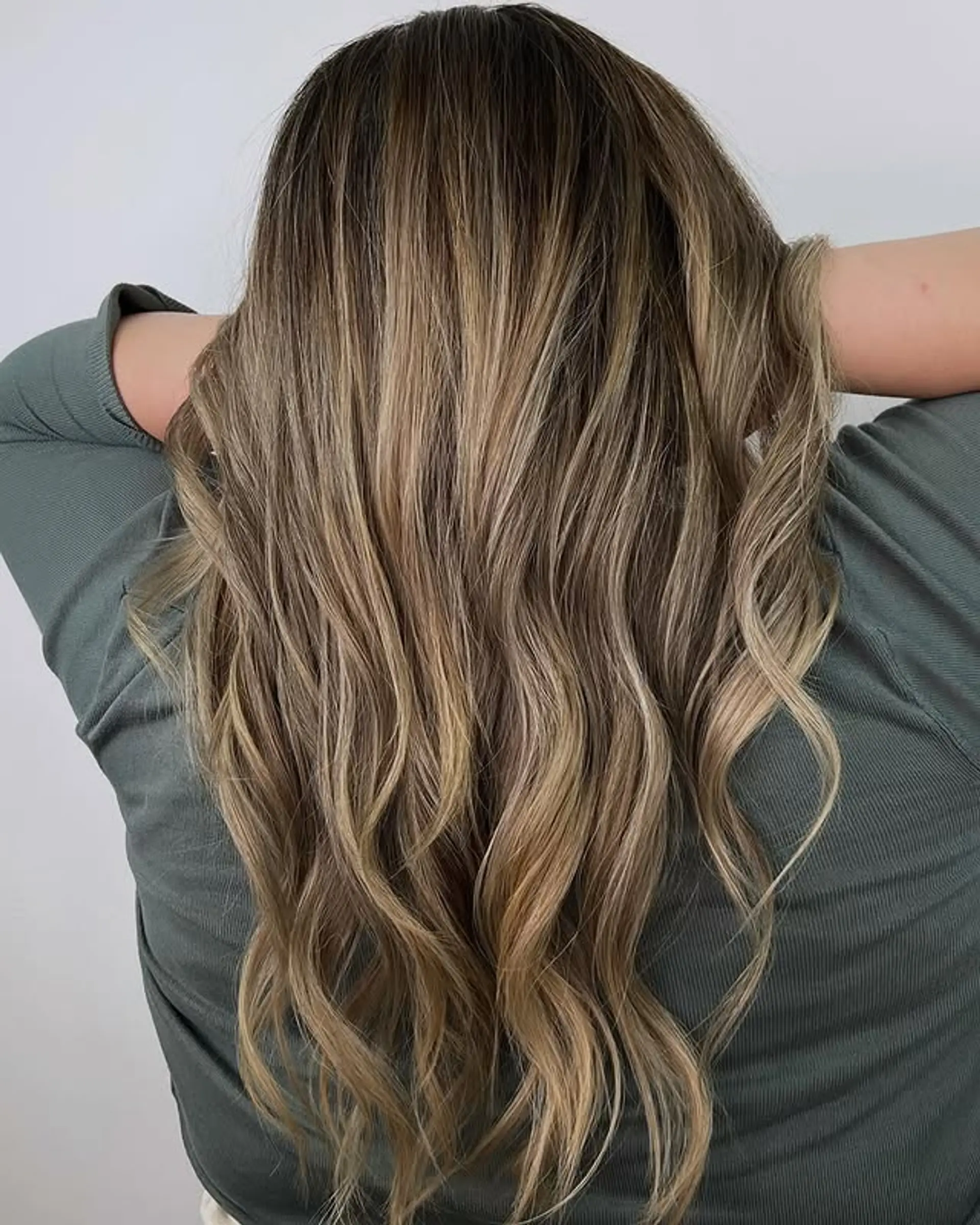 Long, wavy hair with a caramel swirl balayage technique. 1