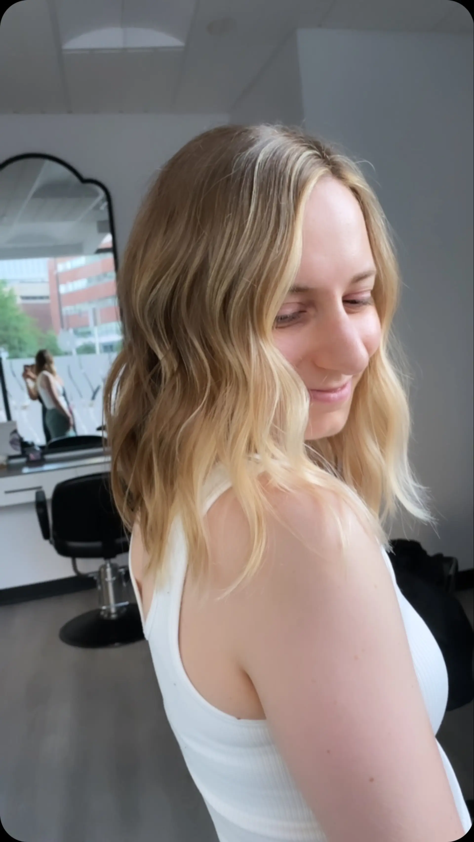 Medium-length textured wavy lob featuring bright face-framing blonde highlights. 1