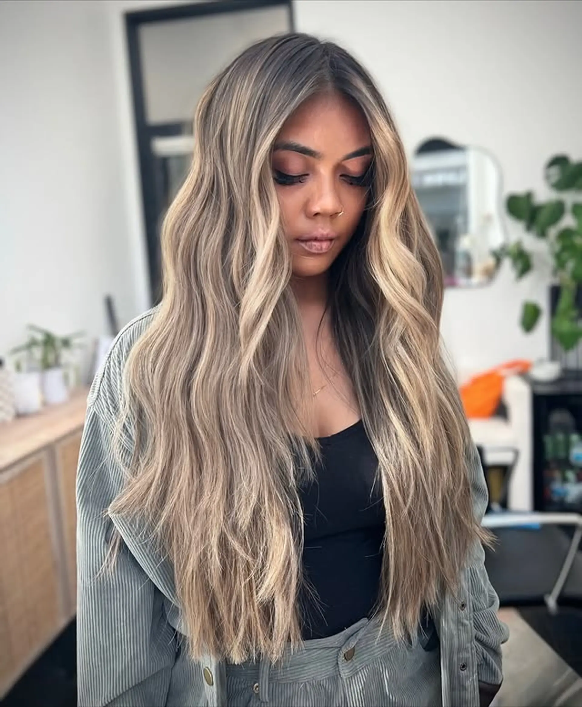 Long, wavy hair with a bronde balayage and face-framing highlights. 1