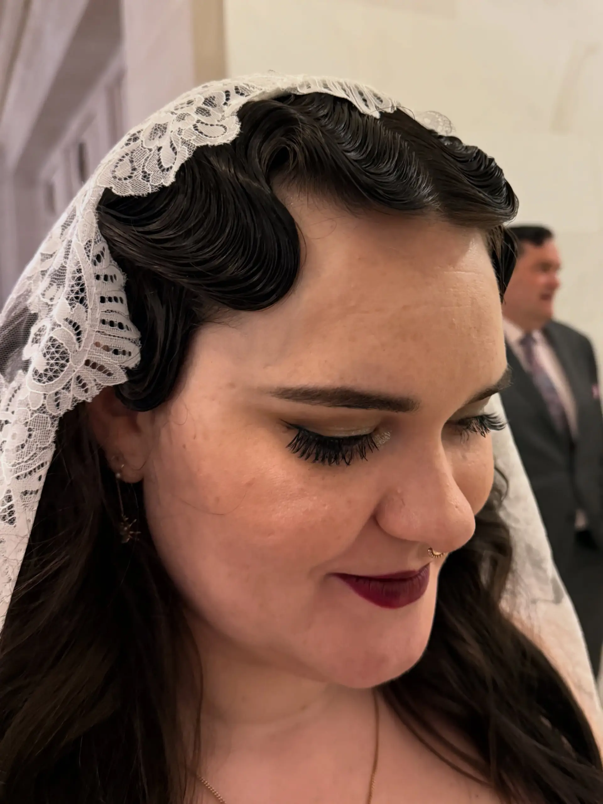 Sleek, sculpted retro finger waves framing the hairline for an elegant bridal look. 1