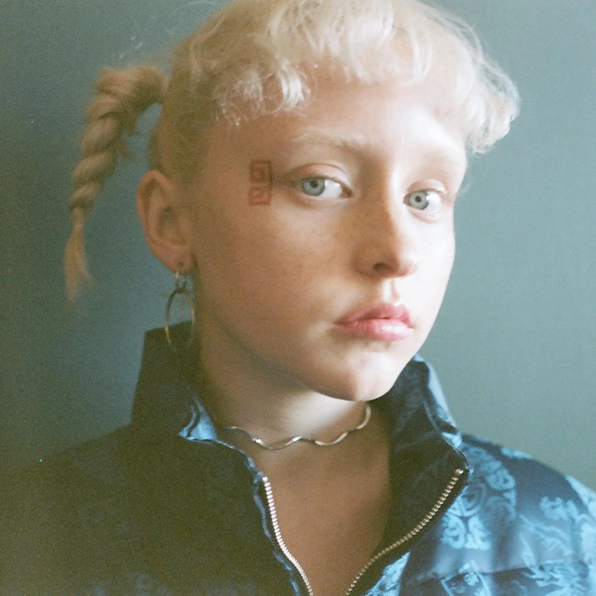 Two loose braids starting from the top and extending to the nape of the neck, featuring a wavy texture and blonde color. Style by @takeohair for OPENING CEREMONY x X-large x X-girl  1